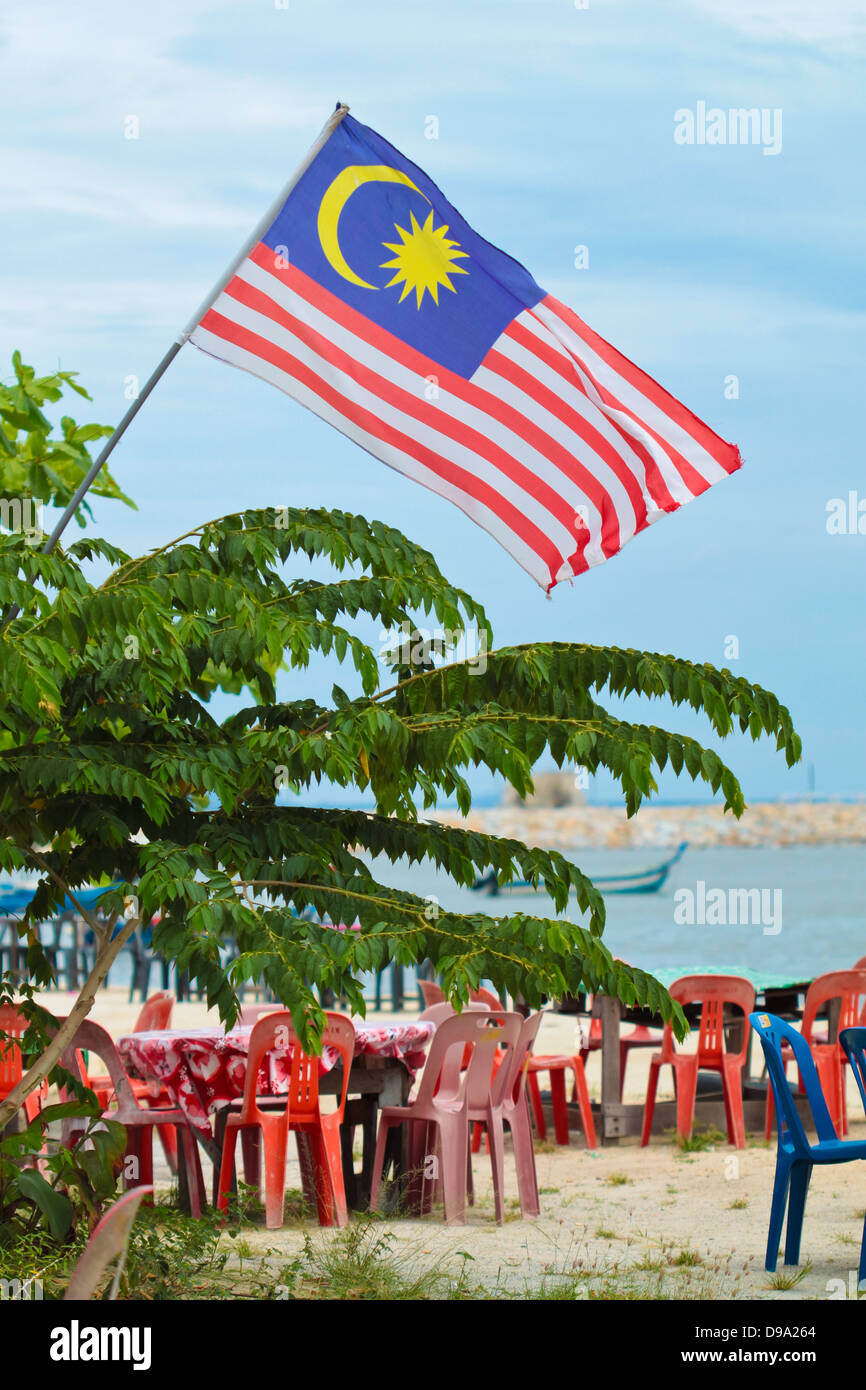 Malaysia flag flying over a restoran on the beach. Stock Photo