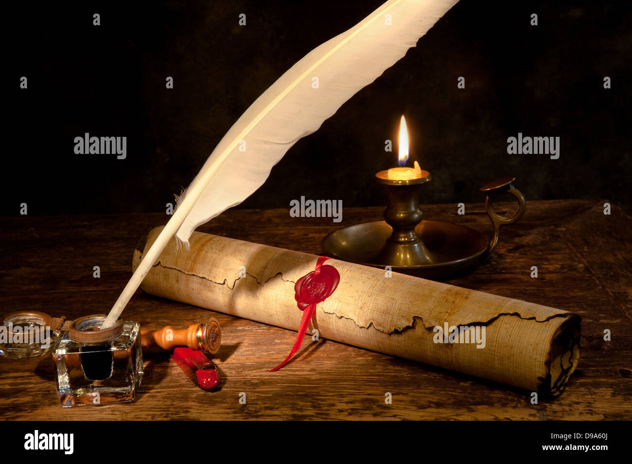 Old parchment or diploma scroll with wax seal and quill pen Stock Photo