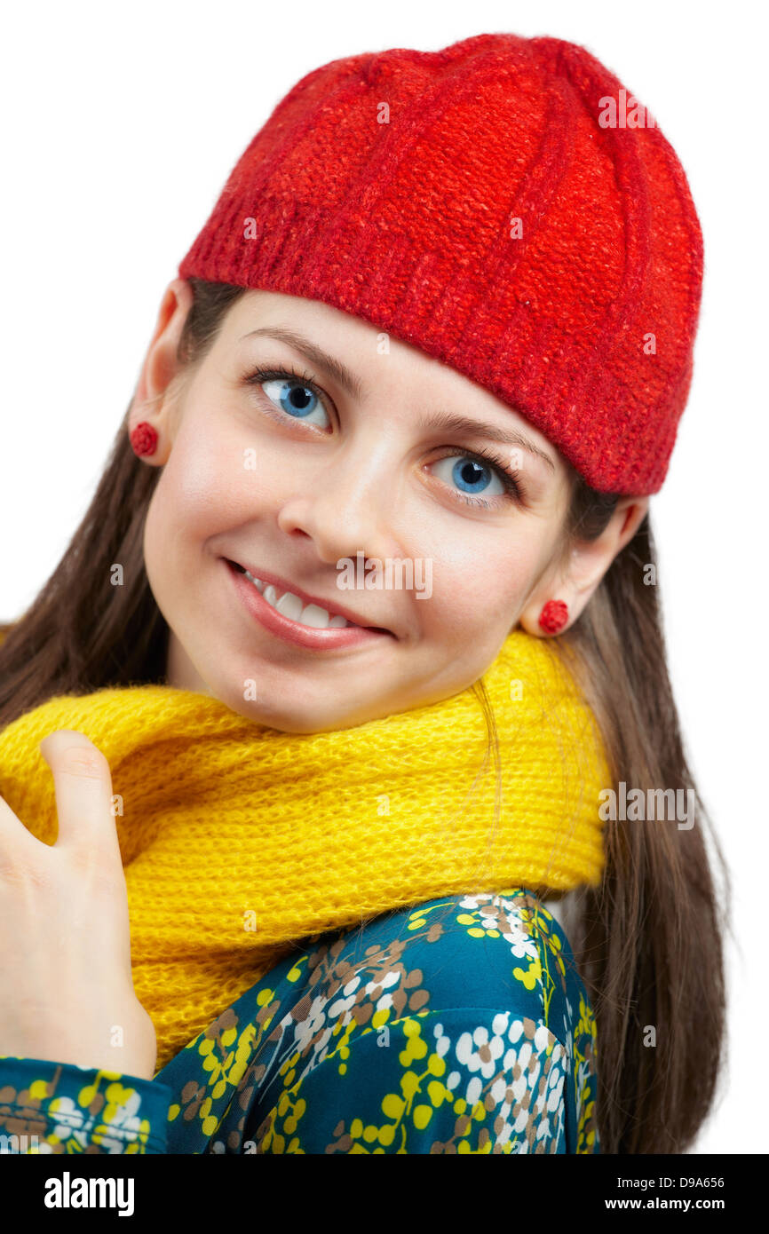 Portrait of a beautiful young woman with yellow scarf and red hat over ...