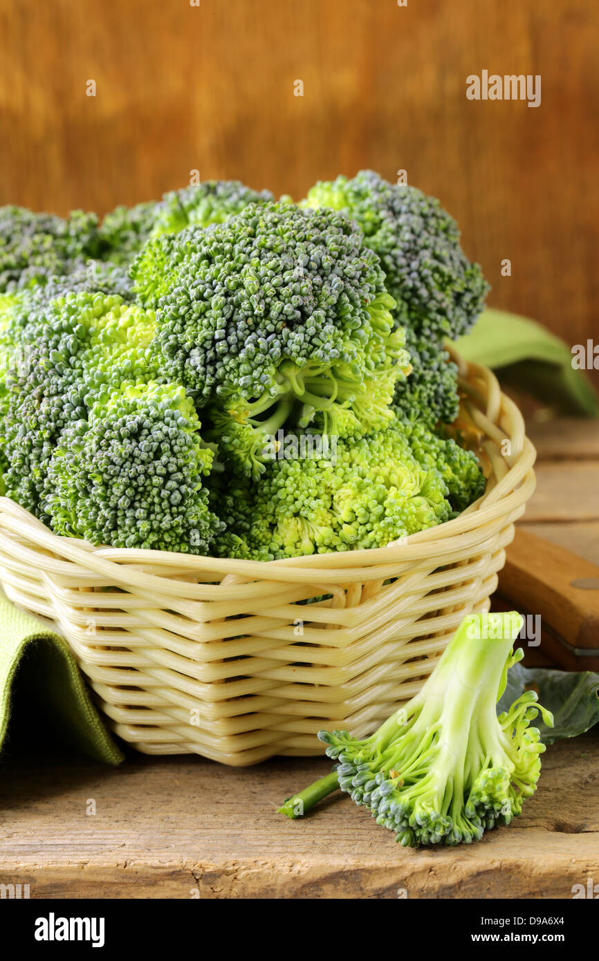 fresh raw green cabbage broccoli in a wicker basket Stock Photo