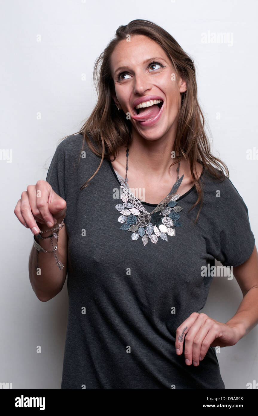 A hip and trendy young woman pulling a face on white background Model release available Stock Photo