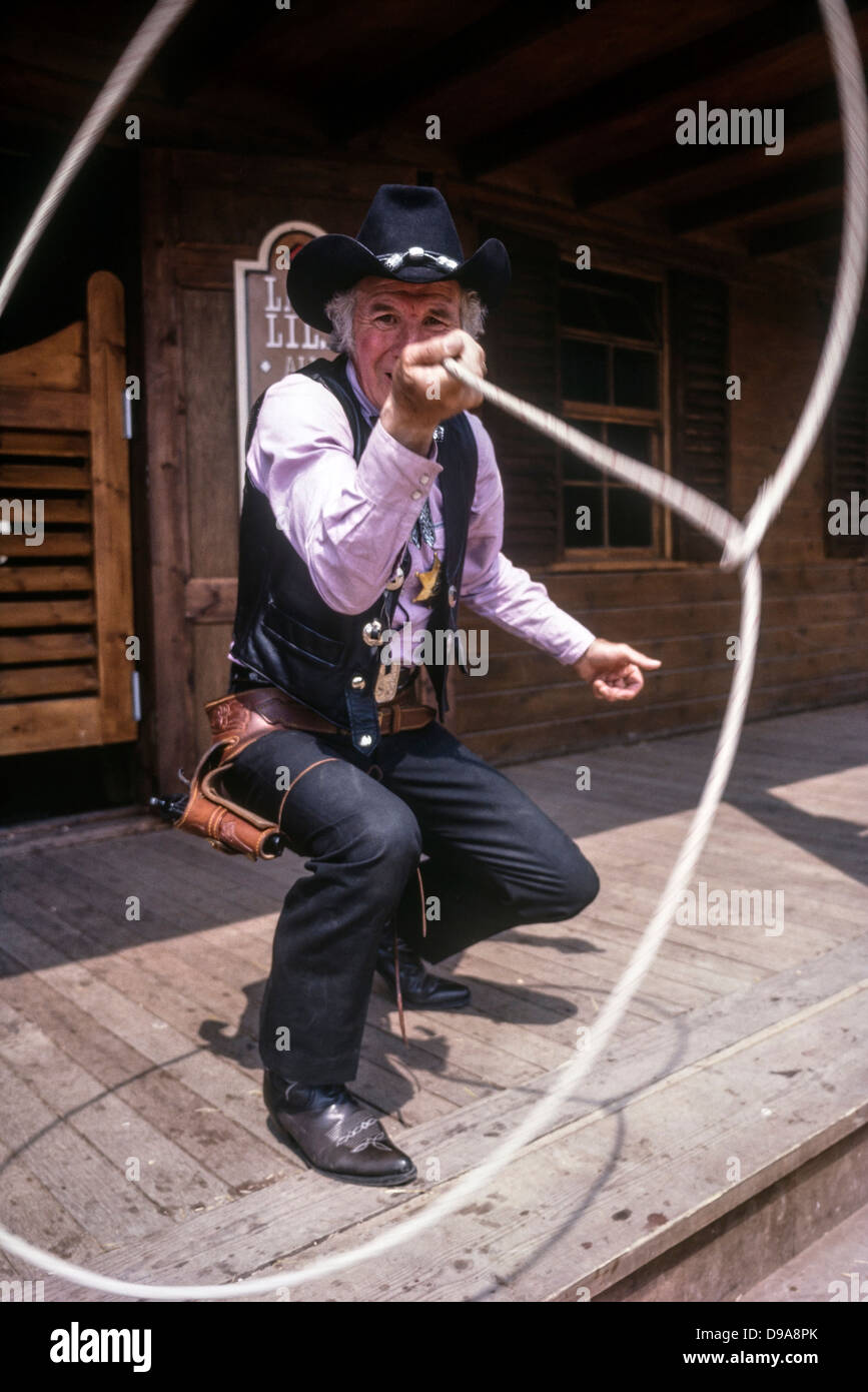 Rex Roper, the cowboy sheriff character throwing a lasso at The American Adventure Theme Park, Ilkeston, Derbyshire Stock Photo