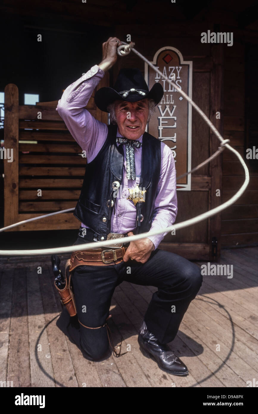 Rex Roper, the cowboy sheriff character throwing a lasso at The American Adventure Theme Park, Ilkeston, Derbyshire, England, UK. Circa 1980's Stock Photo