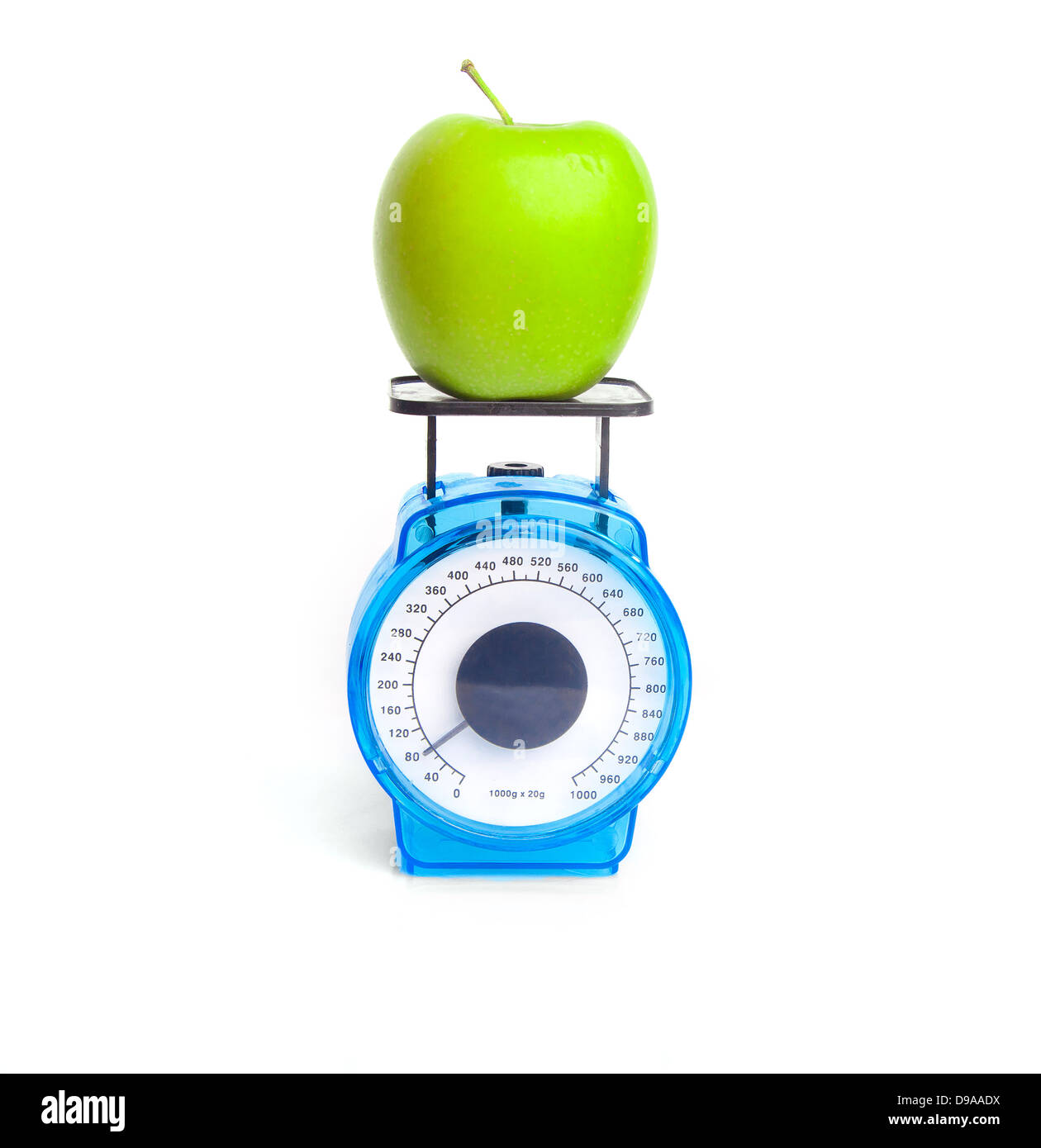 Green apple on scale: weight control concept Stock Photo