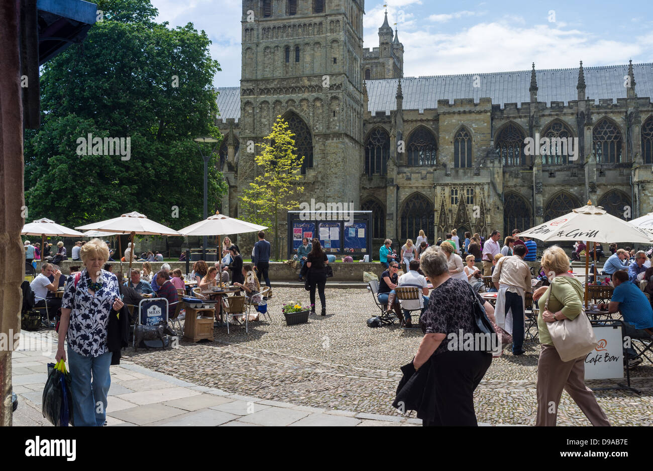 Exeter, Devon, England. May 30th 2013. Exeter Cathedral on a busy day with shoppers and diners outside in the Cathedral yard. Stock Photo