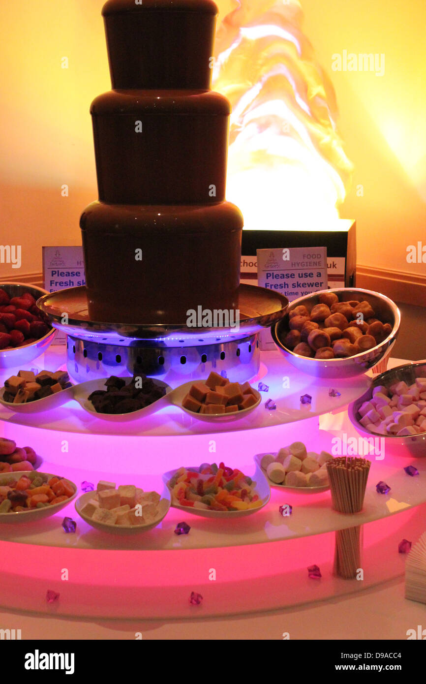 Giant Chocolate Fountain With Lots Of Dipping Bowls Stock Photo Alamy