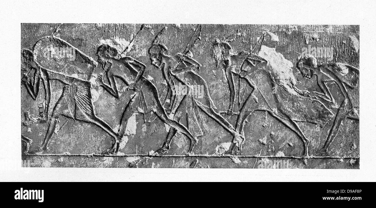 This limestone relief was uncovered in a grave at Akhetaten (Amarna) are funeral attendants of Amenhotep IV (Akhenaten). Stock Photo