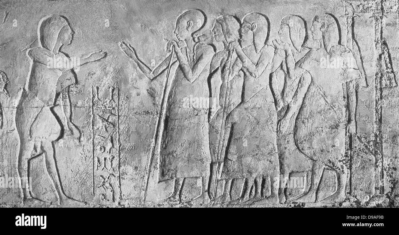 Shown in the early 1920s photo of a limestone relief uncovered in a grave at Akhetaten (Amarna) is the deceased (left) meeting t Stock Photo