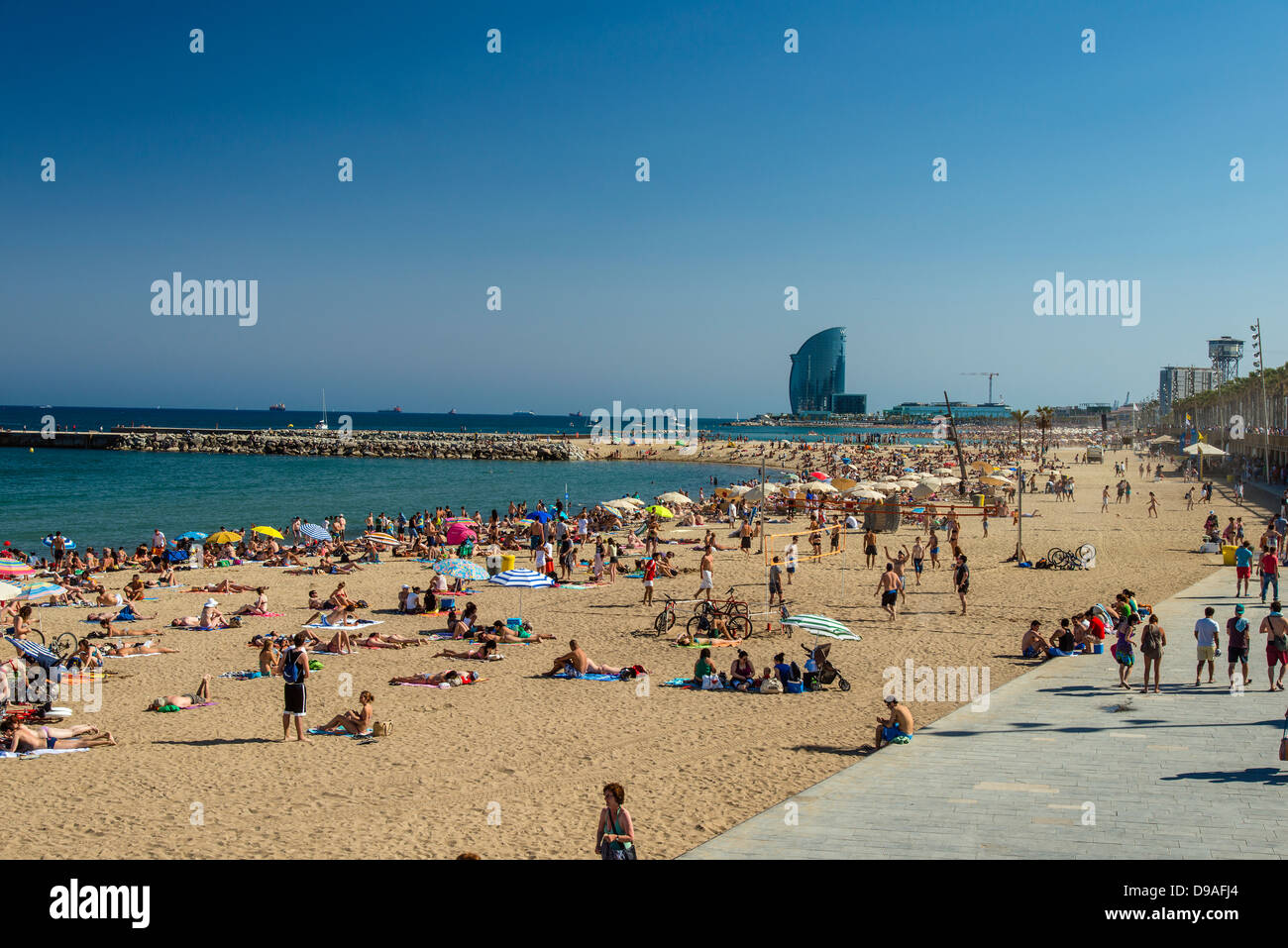 Sunbathers at Somorrostro beach, Barcelona, Catalonia, Spain Stock Photo