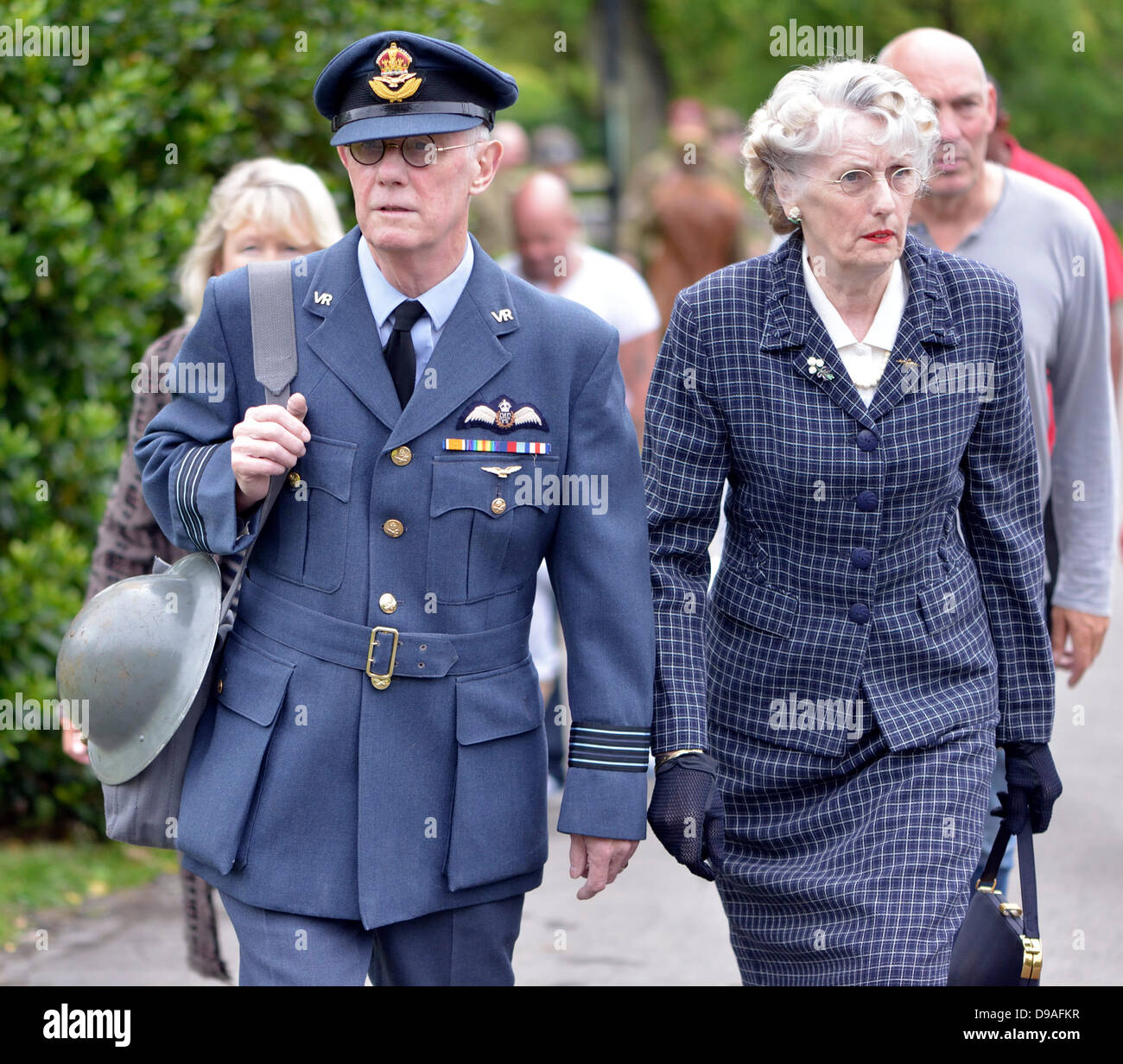 Harrogate, Yorkshire, UK. 16th June, 2013.  A man dressed as a RAF Flight Lieutenant and and a woman in 1940's dress walk through Valley Gardens  at an event in Valley Gardens to raise money for The Magnesia Well Pump Room Project to create an exhibition on mineral springs. Credit:  John Fryer/Alamy Live News Stock Photo