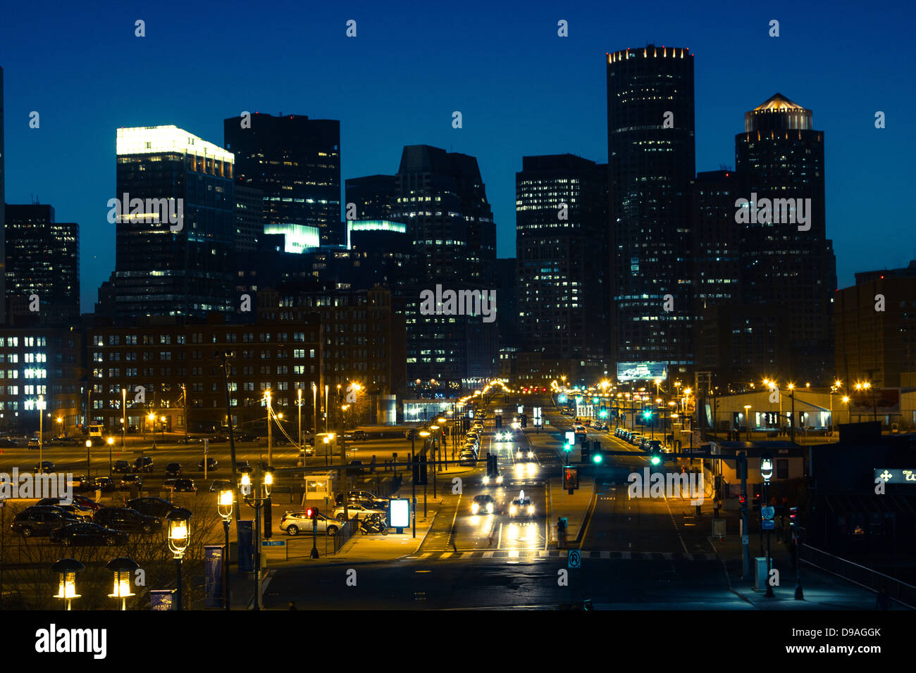 Downtown Boston skyline and Seaport Boulevard as seen from Seaport District at night Stock Photo