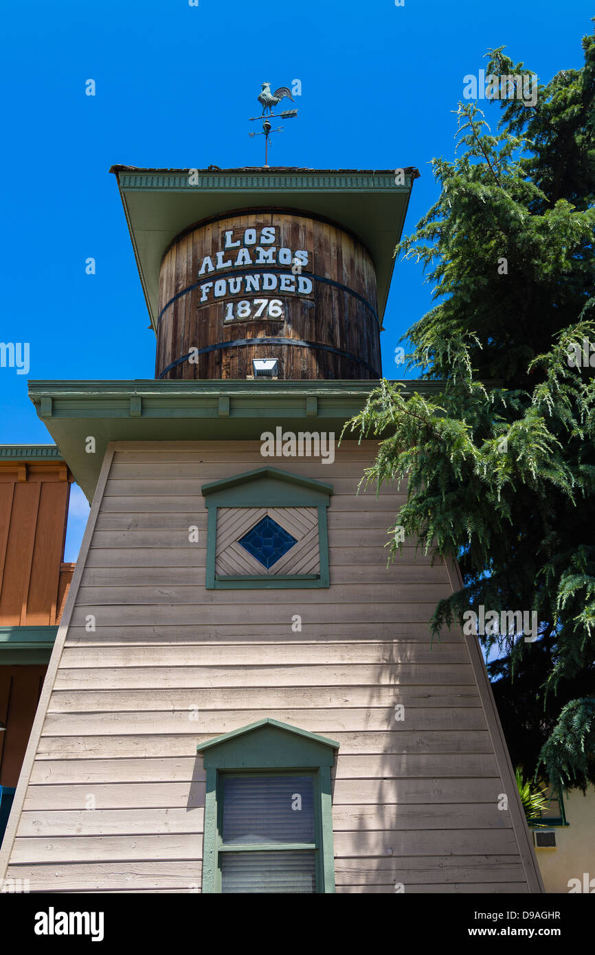 An historical wooden structure with a sign stating the town's founding
