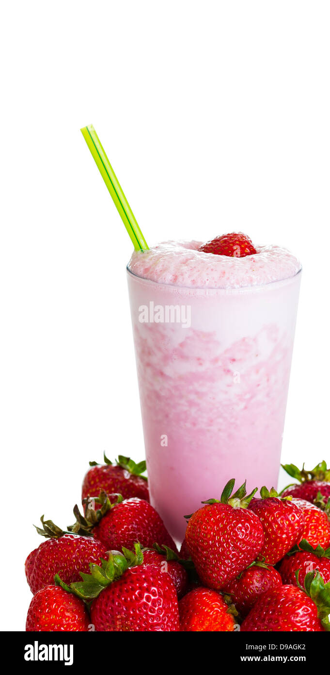 Vertical photo of fresh strawberry milkshake, green straw, ripe berries in front of base of glass on a white background Stock Photo