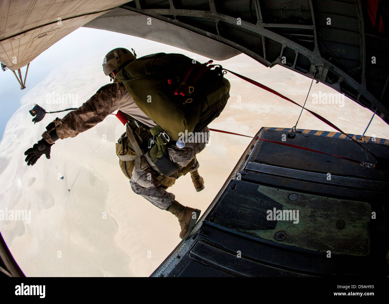 US Marines with the 26th Marine Expeditionary Unit Maritime Raid Force jump out the back of a CH-53E Super Stallion helicopter during parachute operations April 25, 2013 over Qatar. Stock Photo