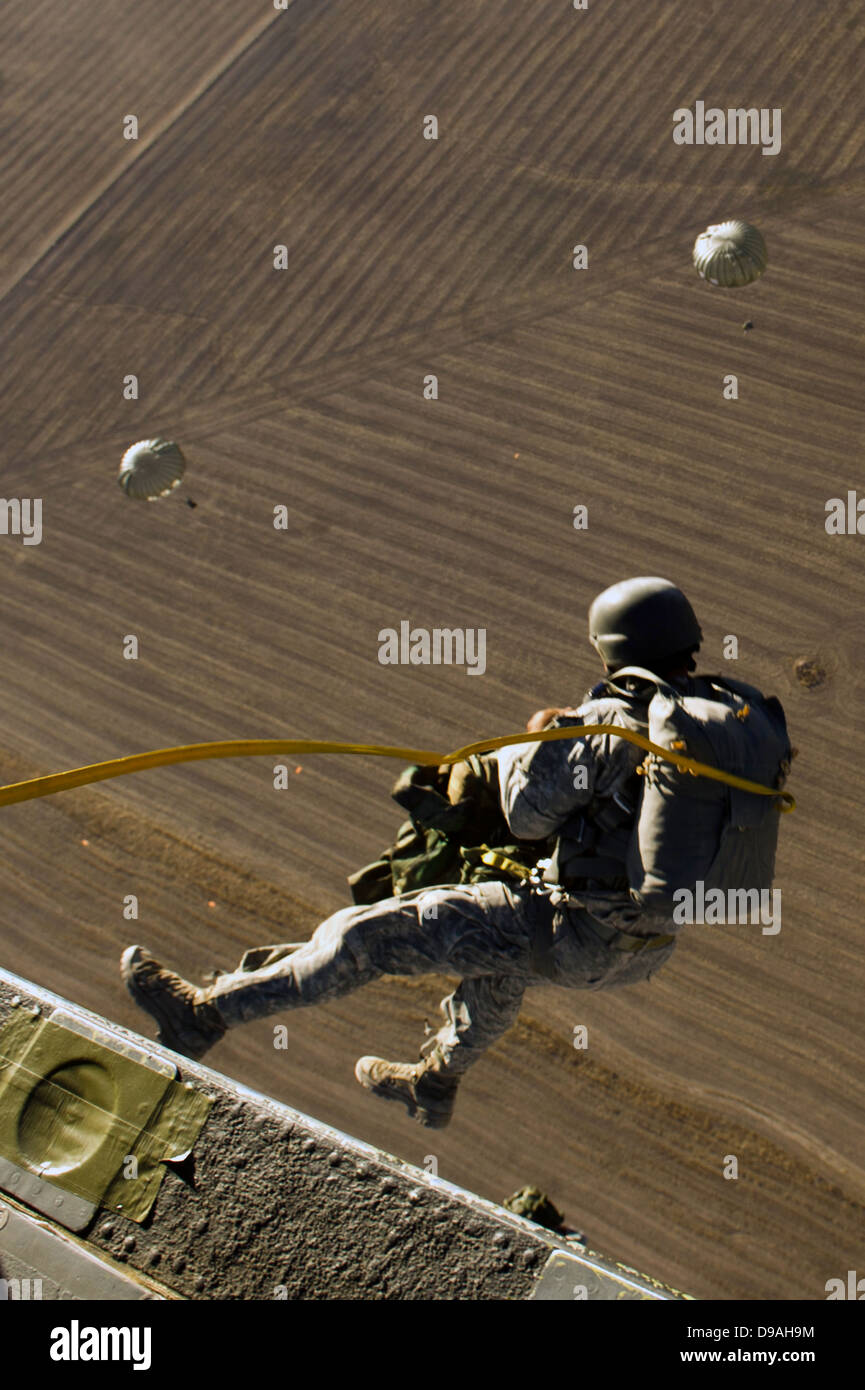 US Army special forces soldiers parachute from a UH-60L Blackhawk helicopter during training June 20, 2012 in Fairfield, Utah. Stock Photo