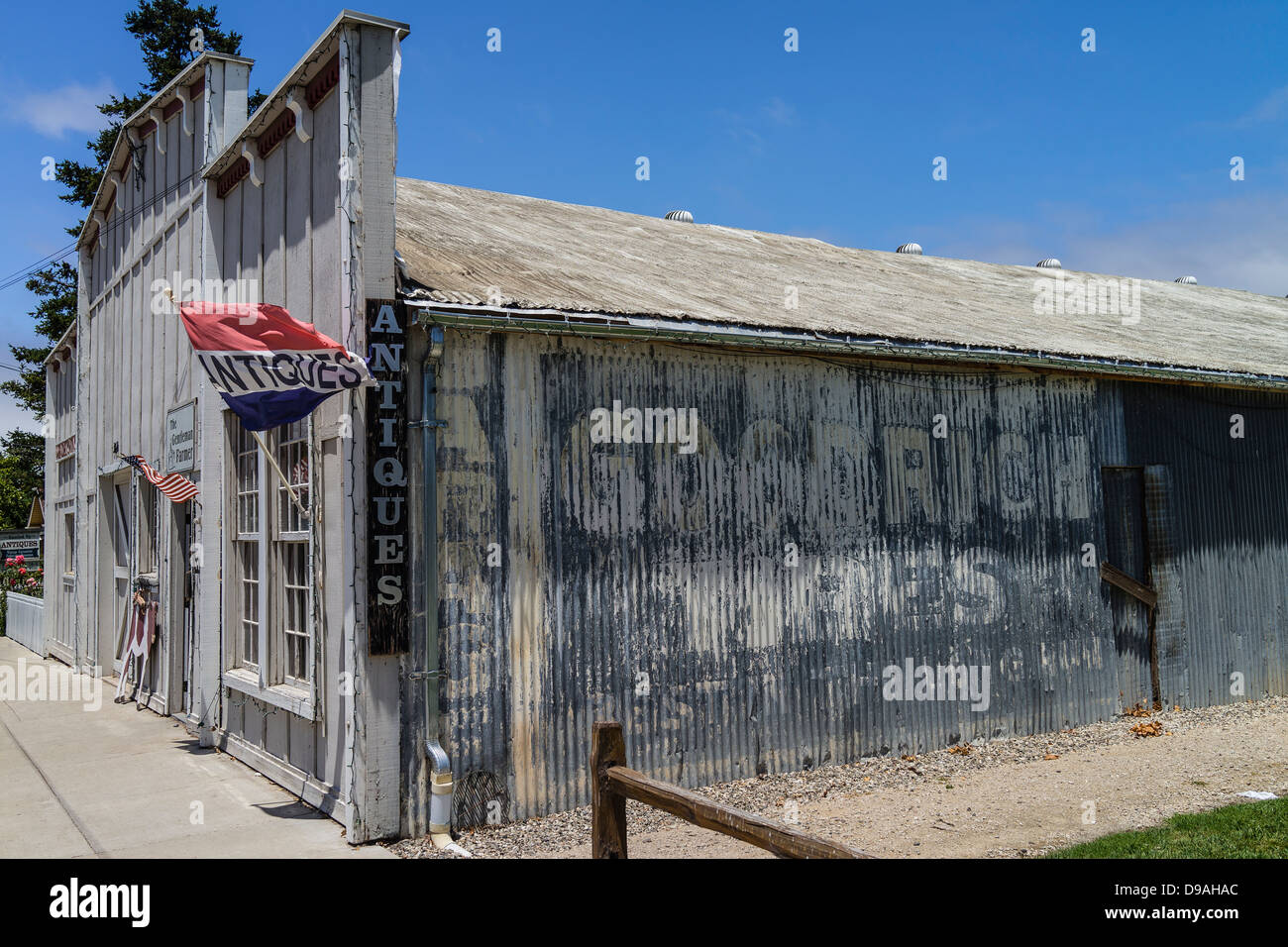 The exterior of an antique store located in an old false front building with weathered steel siding. Stock Photo