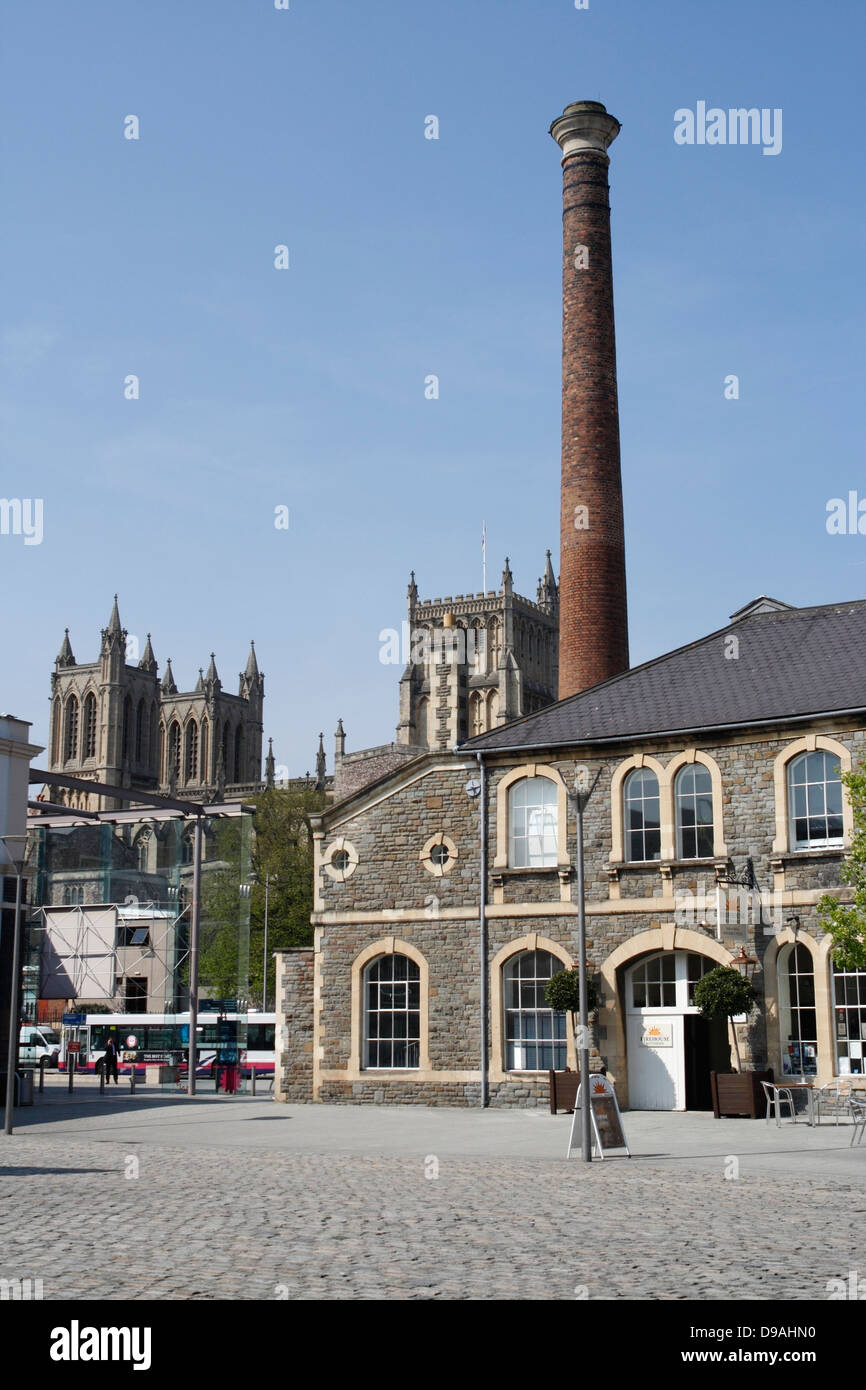 The towers of Bristol cathedral as seen behind the former gas works building from Canons Marsh Stock Photo