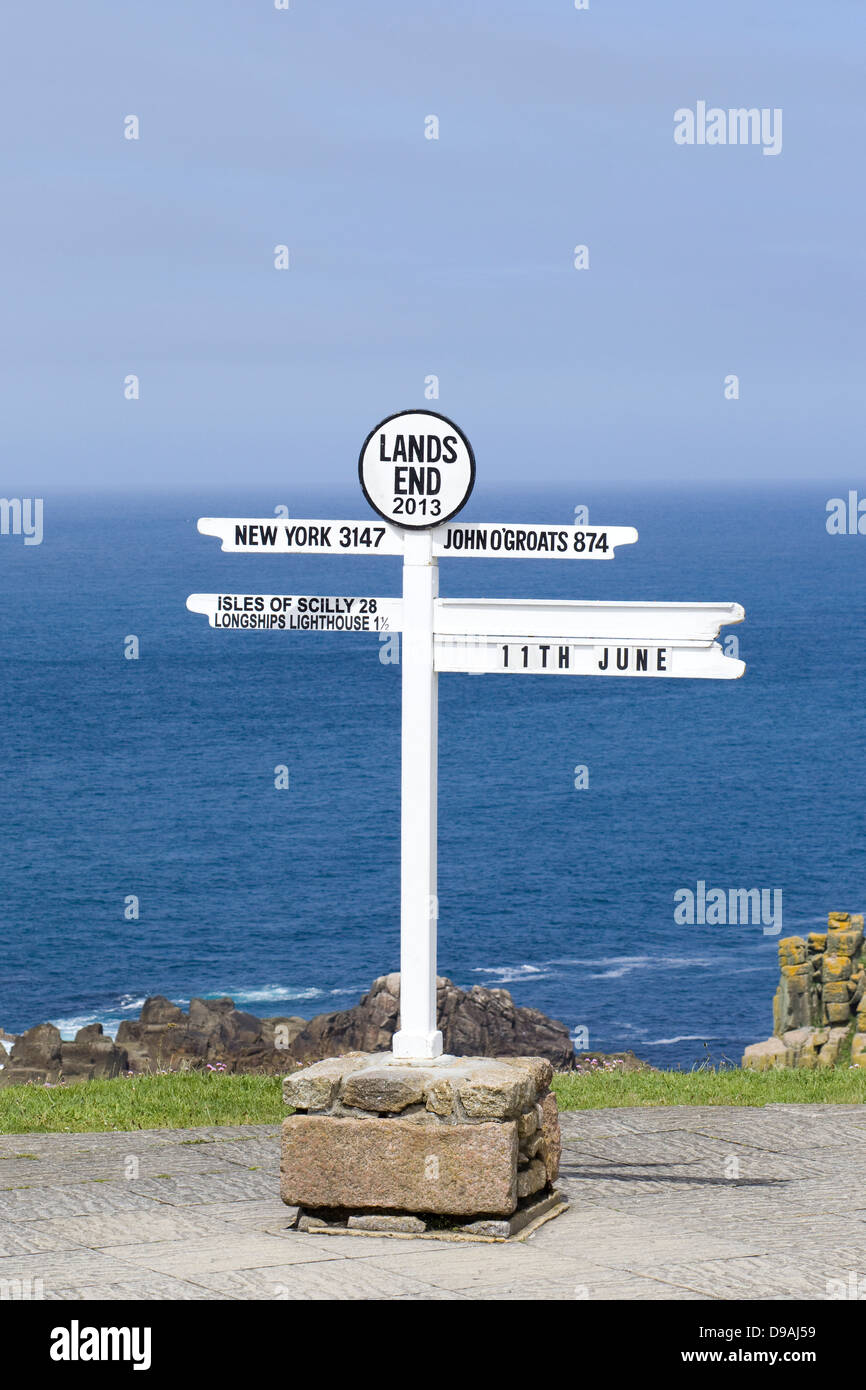 The Lands End Signpost one of Cornwall's most iconic sights with sea and blue sky in Background Stock Photo
