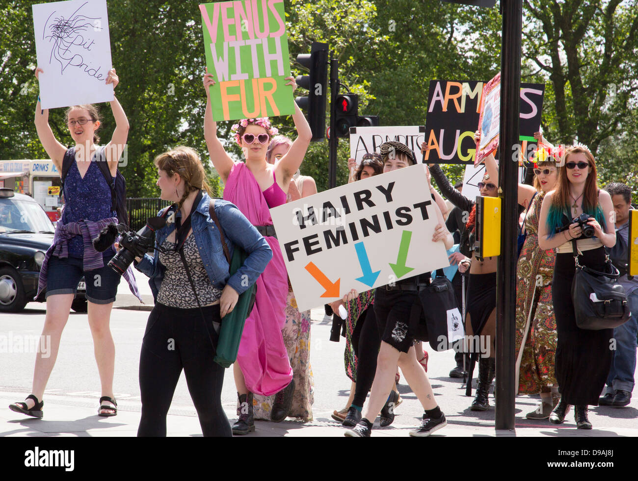 Women with placards at Marble Arch in London to raise awareness of a forthcoming Armpits 4 August sponsorship event. Stock Photo