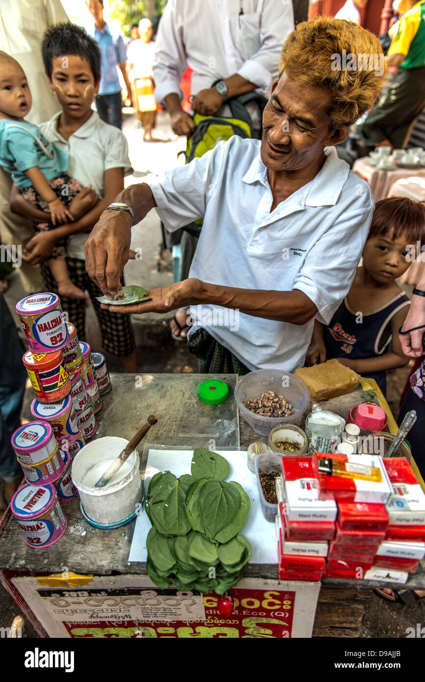 Tobacco street seller preparing a cigar Rangoon Yangon Myanmar Burma Stock Photo