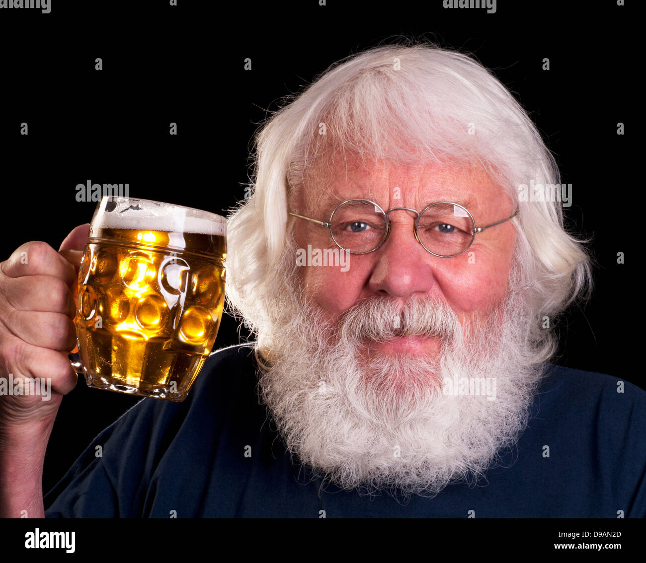 Beer - older bearded man drinking a beer outside the pub Stock Photo
