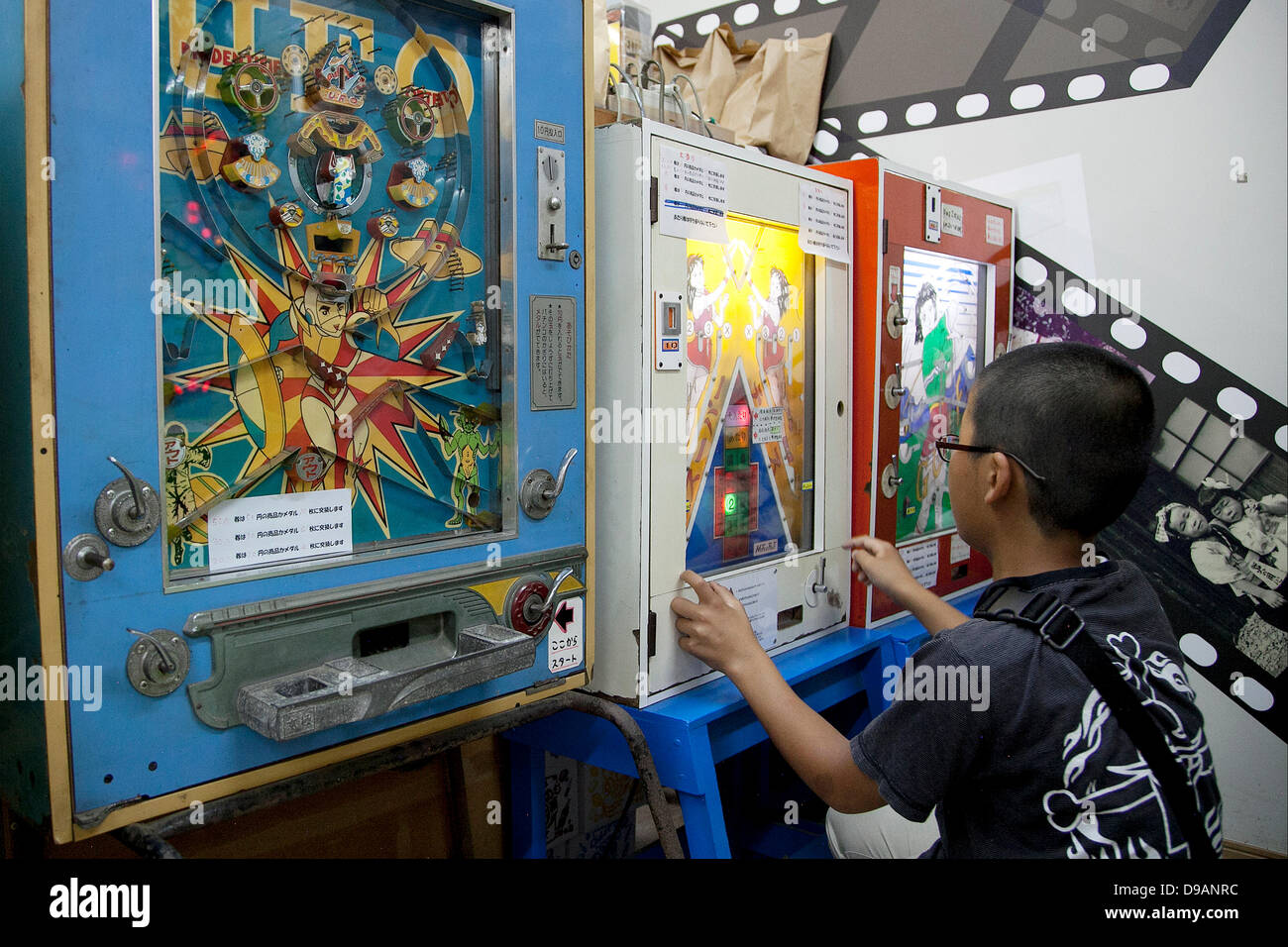 Tokyo, Japan - A kid plays with retro game machine at the Traditional Sweet  Shop and Game Museum in Tokyo, June 16, 2013. The Traditional Sweet Shop  and Game Museum opened in