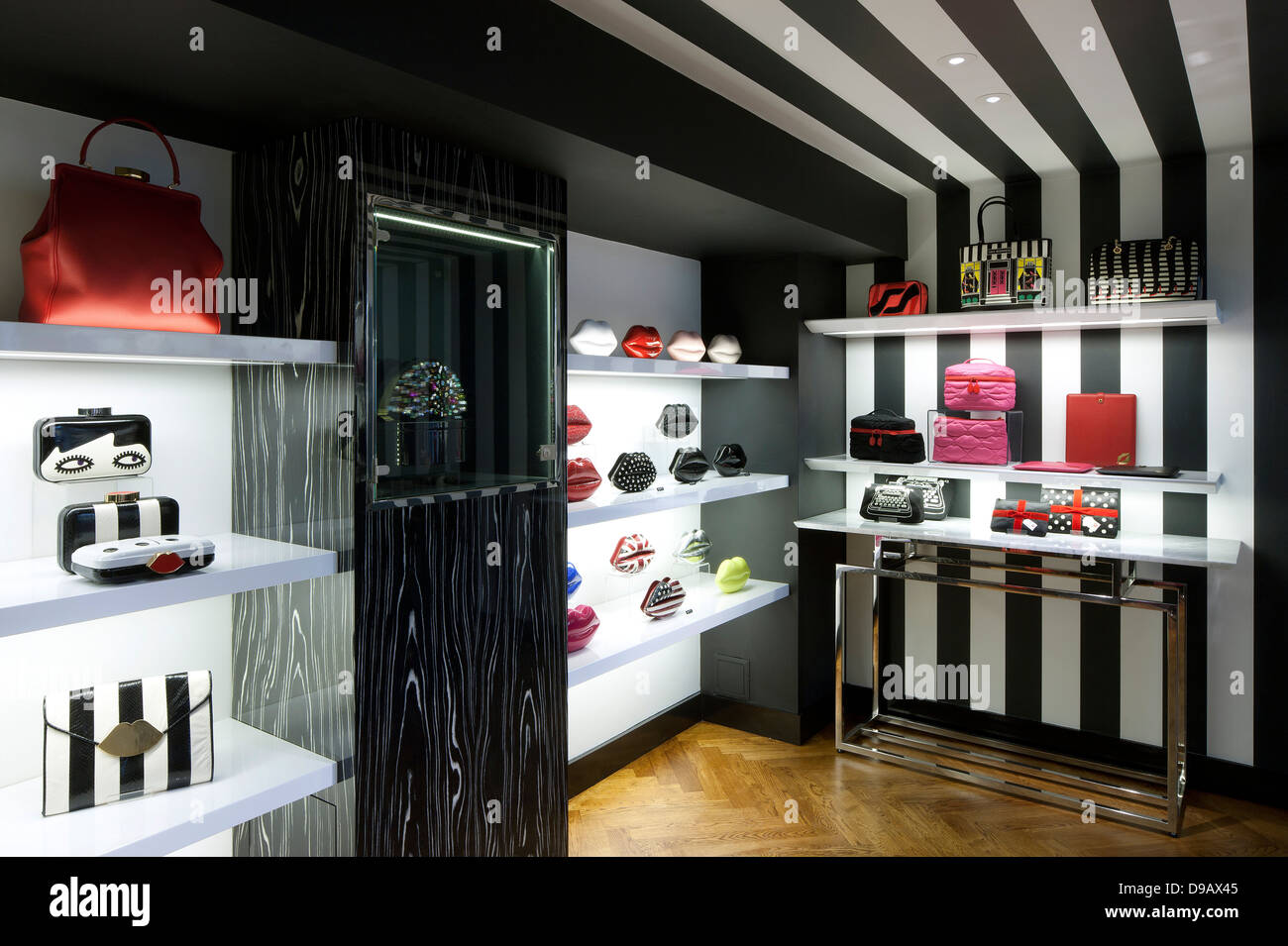 Lulu Guinness, London, United Kingdom. Architect: HMKM, 2013. Rear of store with floating shelves, table display, stripy black a Stock Photo