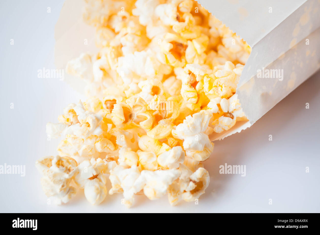 Fresh butter popcorn falling out of the bag Stock Photo Alamy
