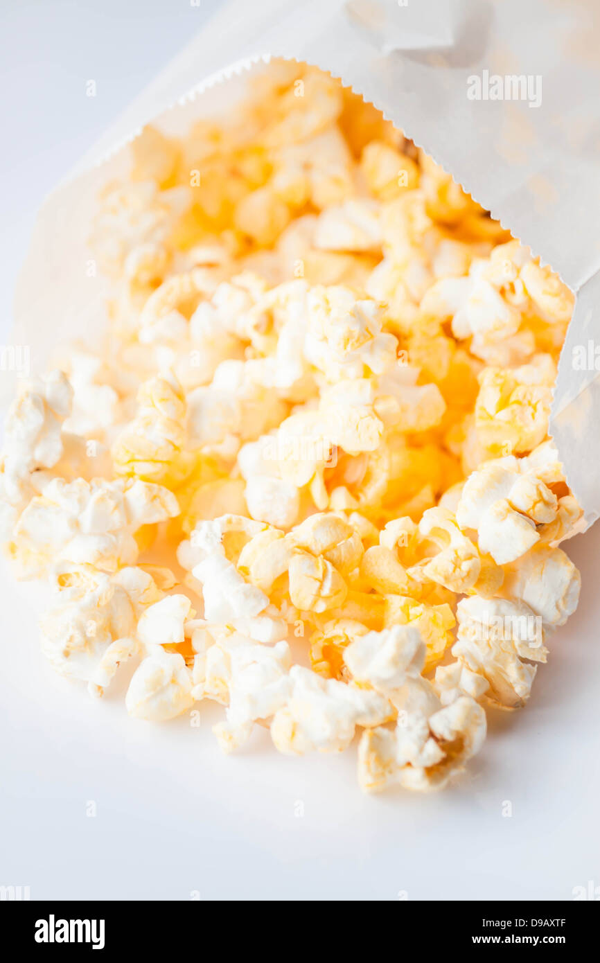 Fresh butter popcorn falling out of paper packet Stock Photo Alamy