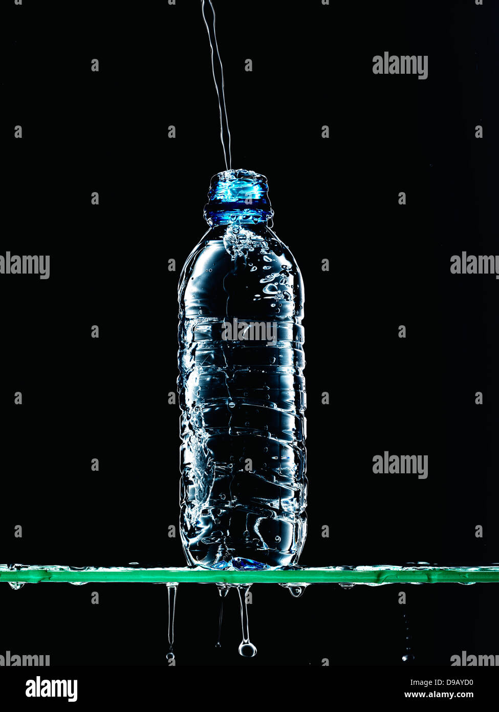 Water pouring in bottle against black background Stock Photo Alamy