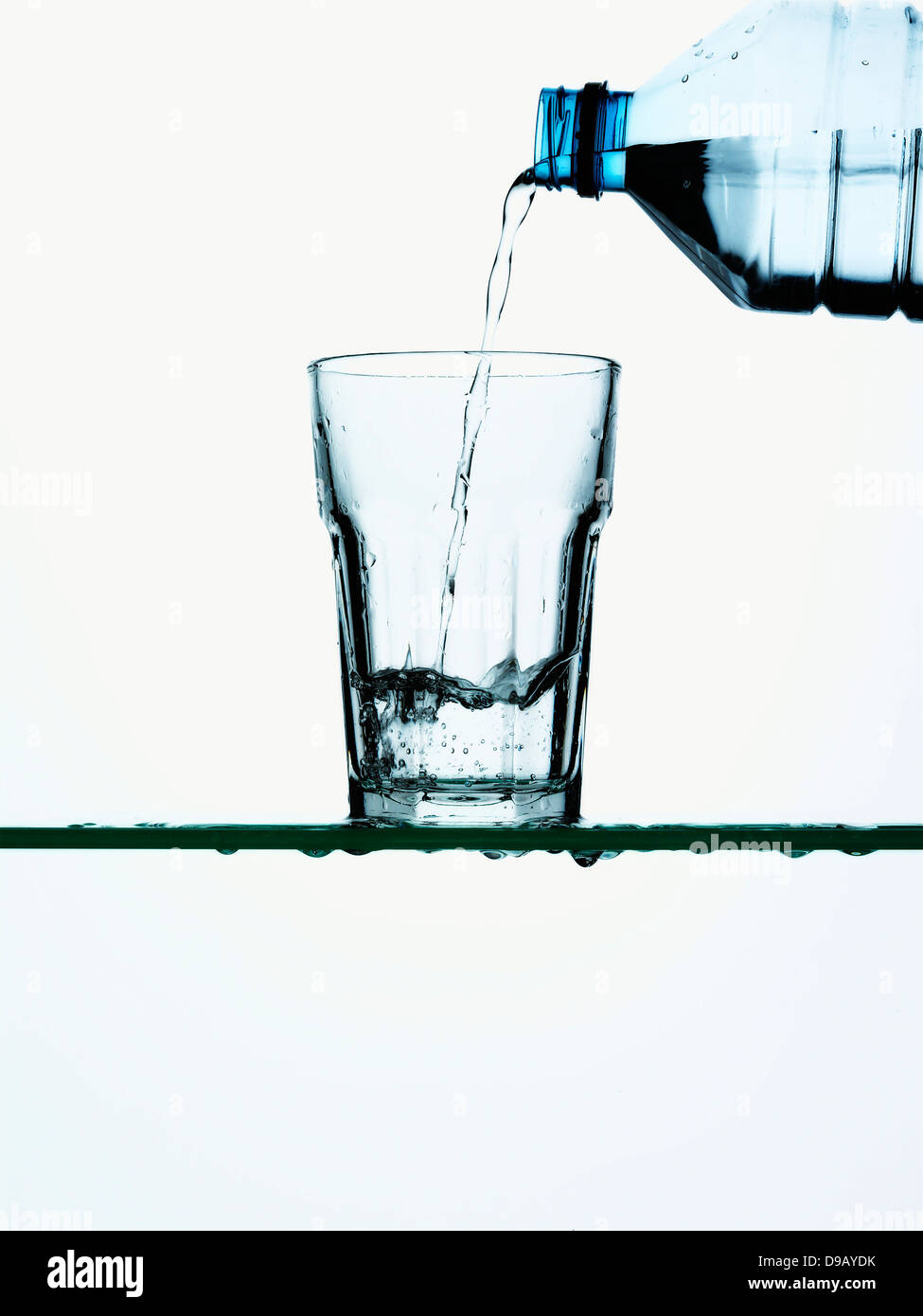 Water being poured into glass from bottle Stock Photo Alamy