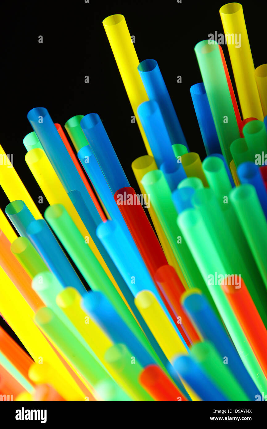 Assortment of colorful drinking straws on black background Stock Photo