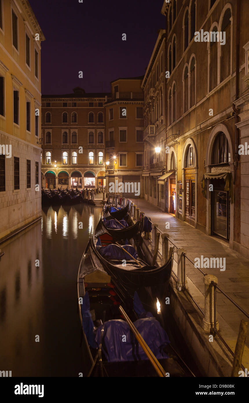Italy, Venice, Gondalas on little canal near St Mark's Square at night Stock Photo