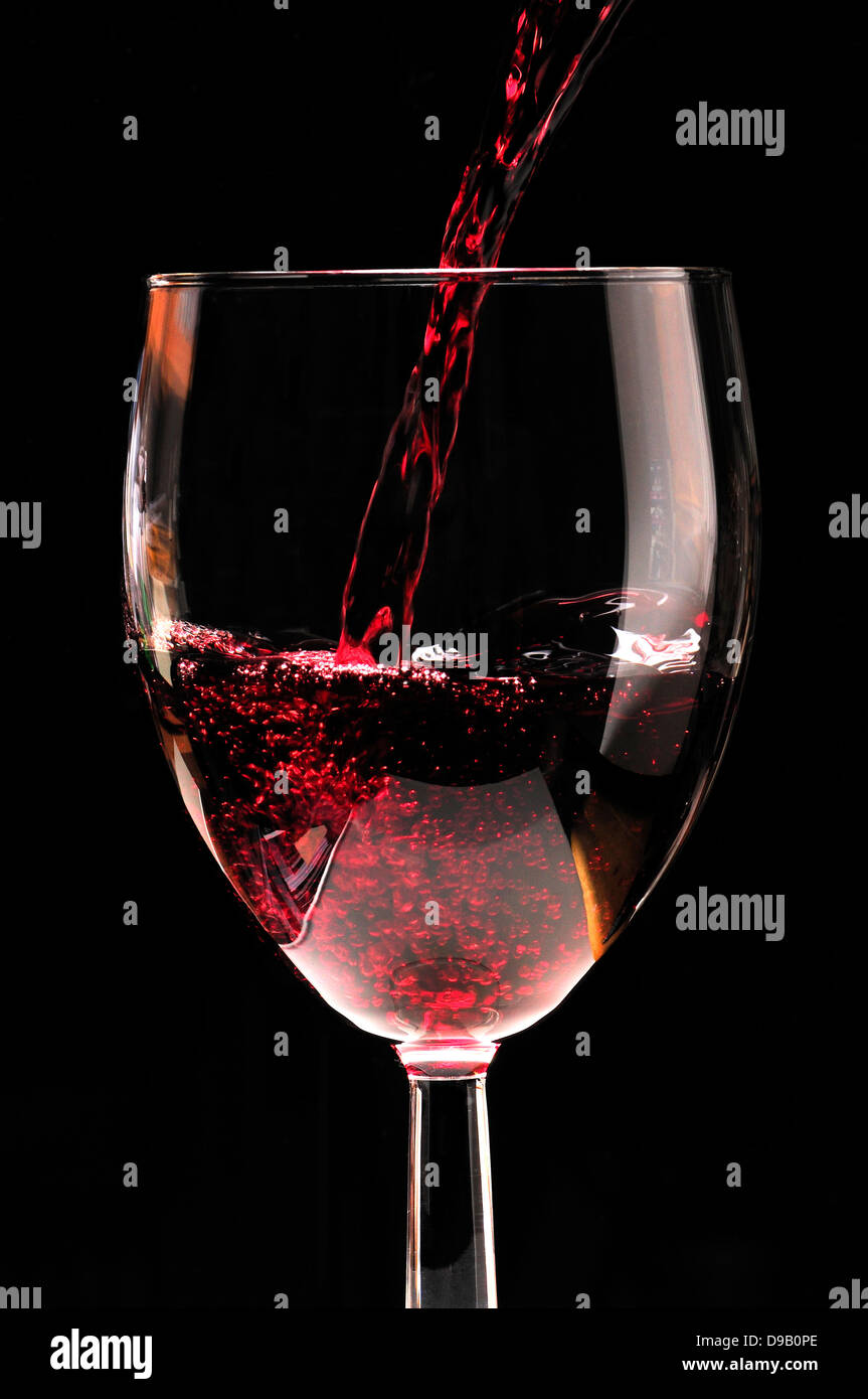 Red wine pouring into a glass Stock Photo