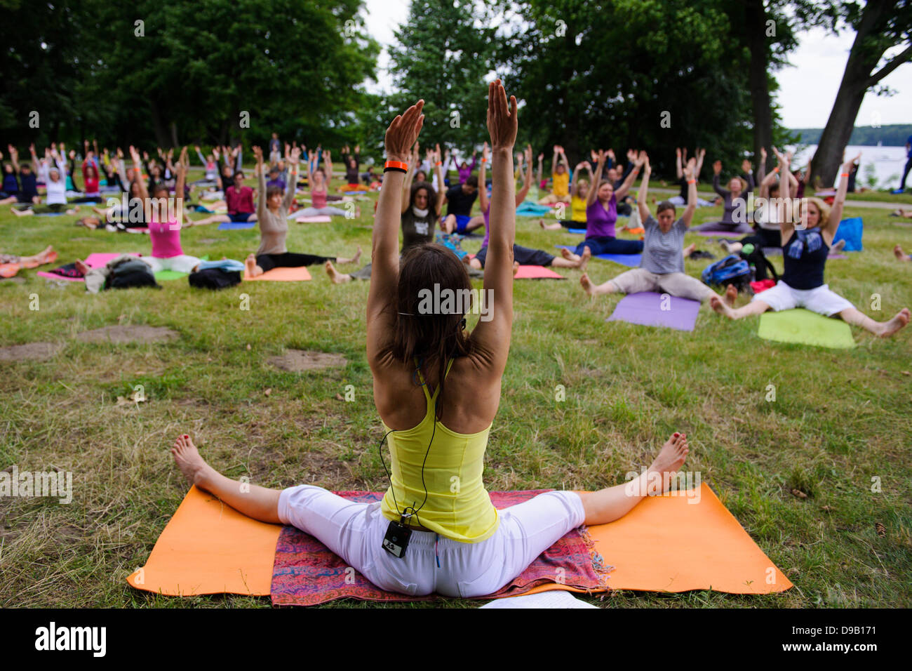 Participants moves at the 9th Berlin Yoga Festival at Wannsee in Berlin, Germany, 16 June 2013. The Berlin Yoga Festival is Europe's largest yoga event.  Photo: picture alliance / Robert Schlesinger Stock Photo