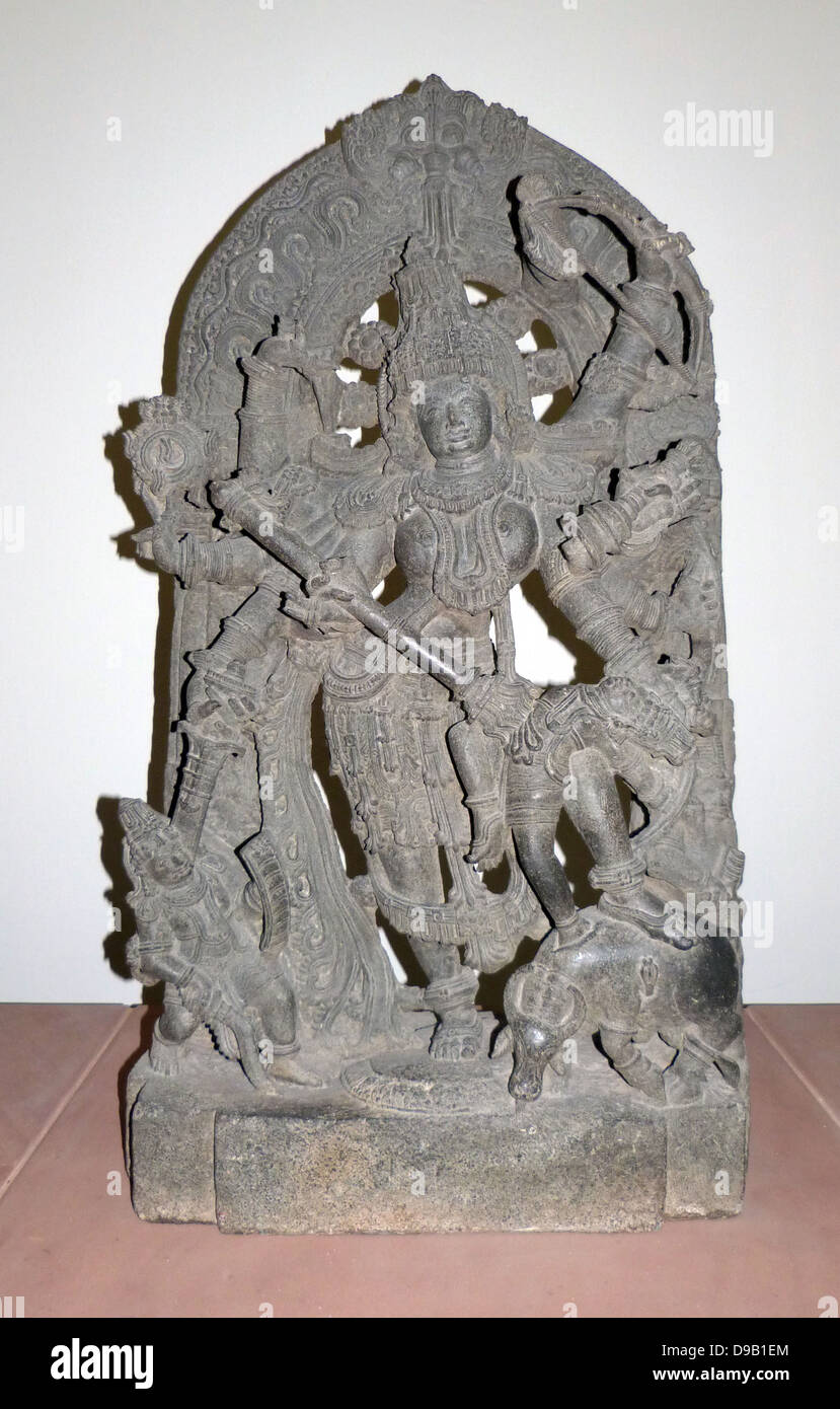 Durga as Mahisasuramardini (circa 1240-60) Hoysala period.  The goddess Durga represents the shakti or female energy of the god Shiva.  Her eight arms would wield sacred weapons against the forces of evil. Here she is shown in her ferocious form as the sl Stock Photo