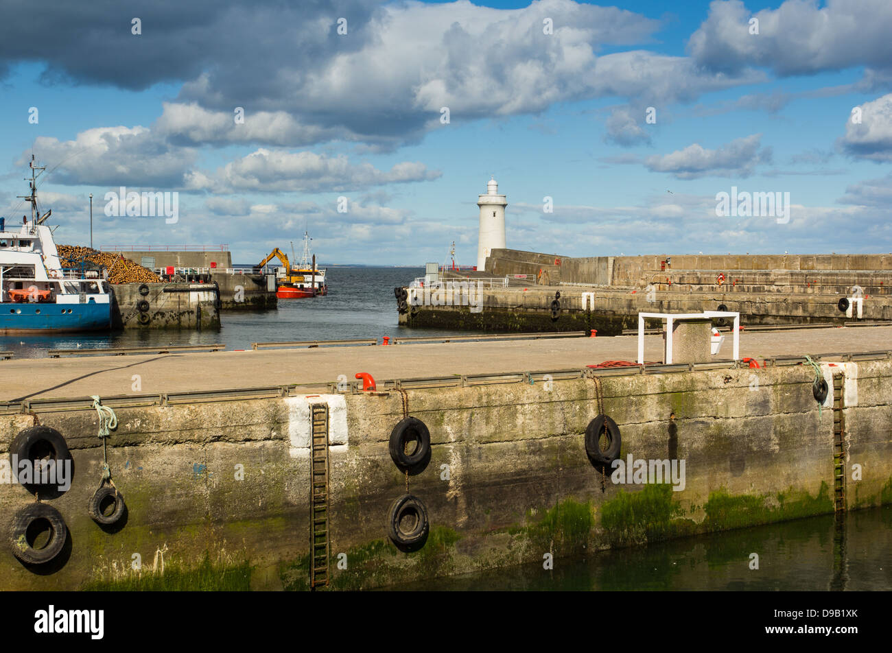 BUCKIE HARBOUR WITH A DREDGER CLEARING SAND FROM THE PORT ENTRANCE MORAY COAST SCOTLAND Stock Photo