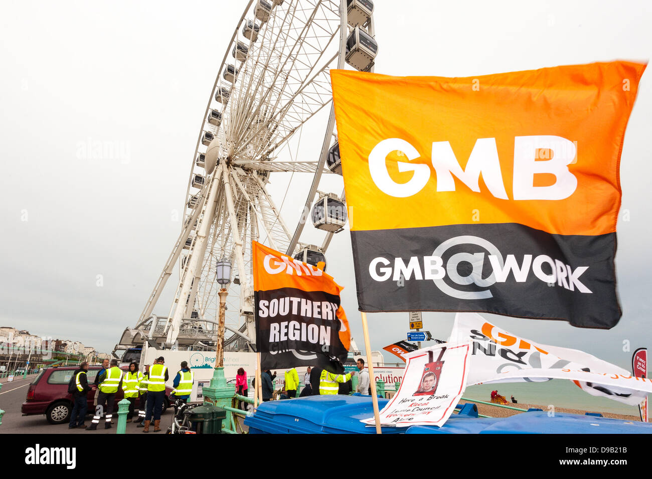 Brighton, UK. 17th June, 2013. Council workers protest against paycuts in Brighton by the Brighton Wheel. Refuse collecters and street cleaners are on strike in Brighton following attempts to cut their pay causing the city's streets to pile up with uncollected rubbish.  photo Credit: Julia Claxton/Alamy Live News Stock Photo