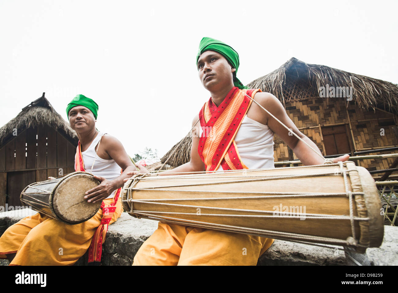 Naga tribal men playing musical instrument, Hornbill Festival, Kohima ...