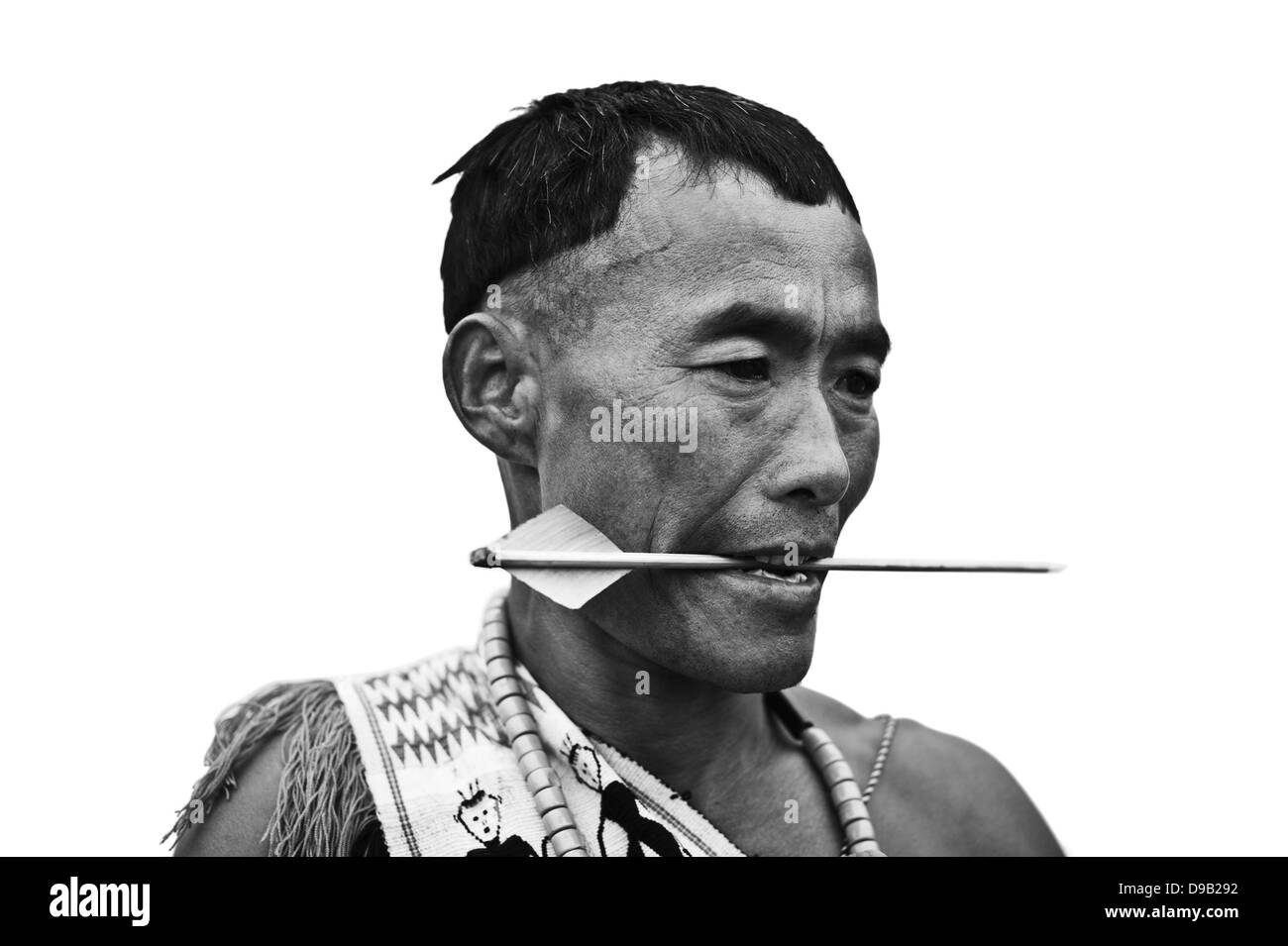 Naga tribal warrior holding a dart in his mouth, Hornbill Festival, Kohima, Nagaland, India Stock Photo
