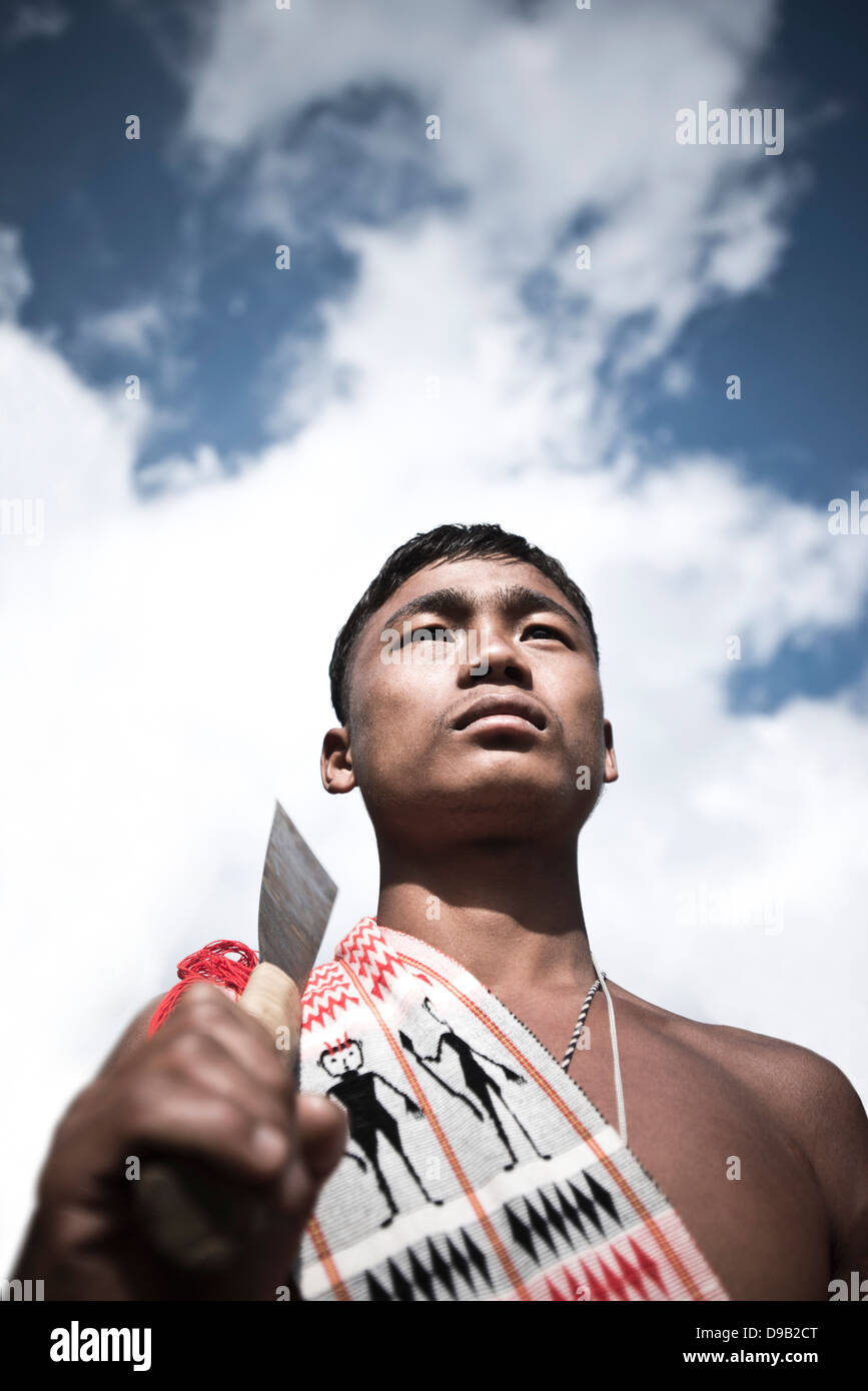 Naga tribesman holding a machete during the annual Hornbill Festival at