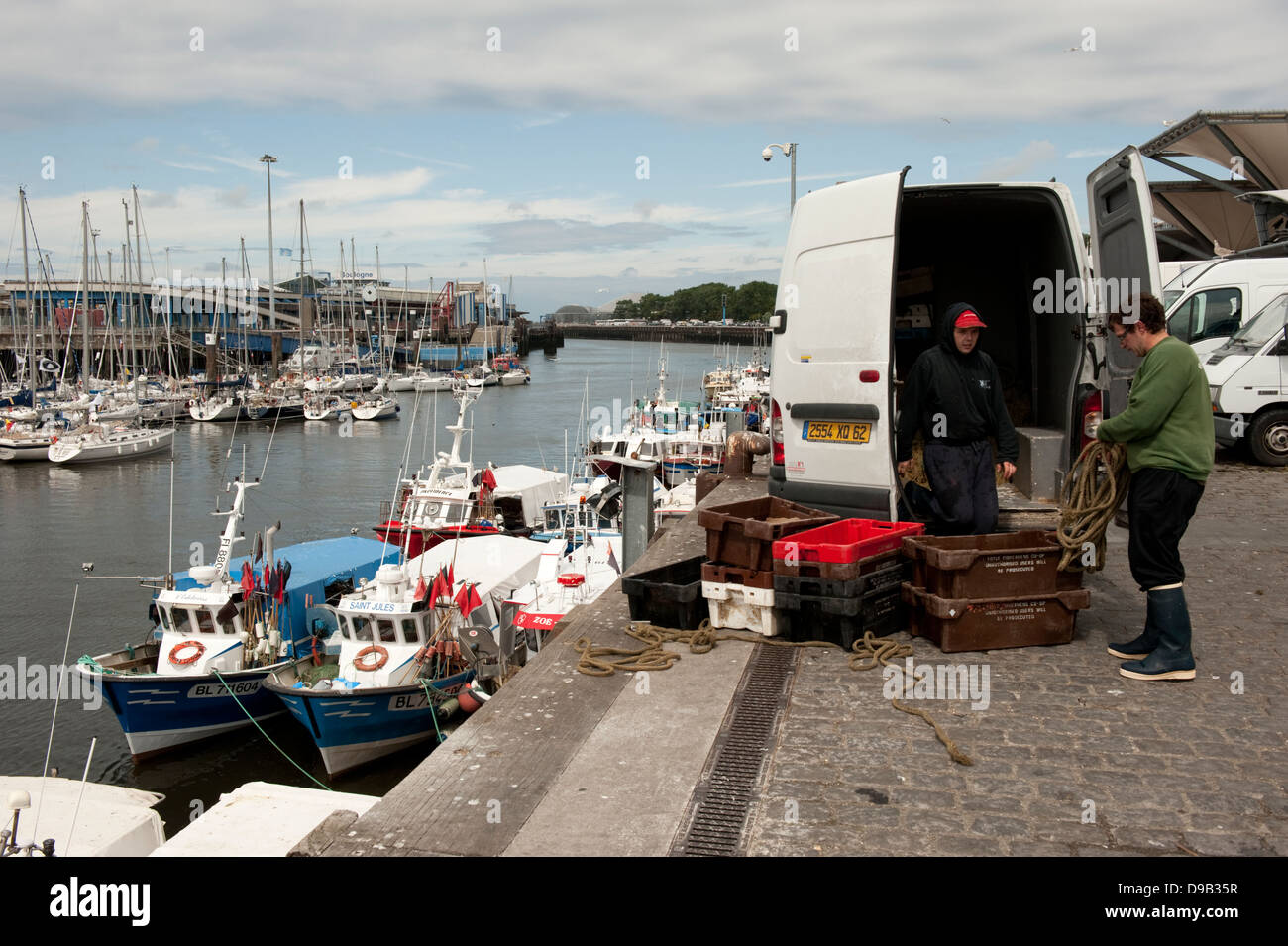 Fishermen unloading fishing boats Boulogne-sur-Mer France Europe Stock Photo
