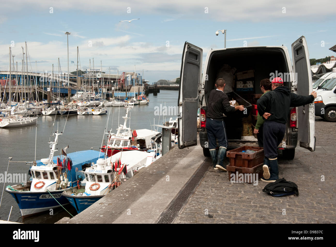 Fishermen unloading fishing boats Boulogne-sur-Mer France Europe Stock Photo