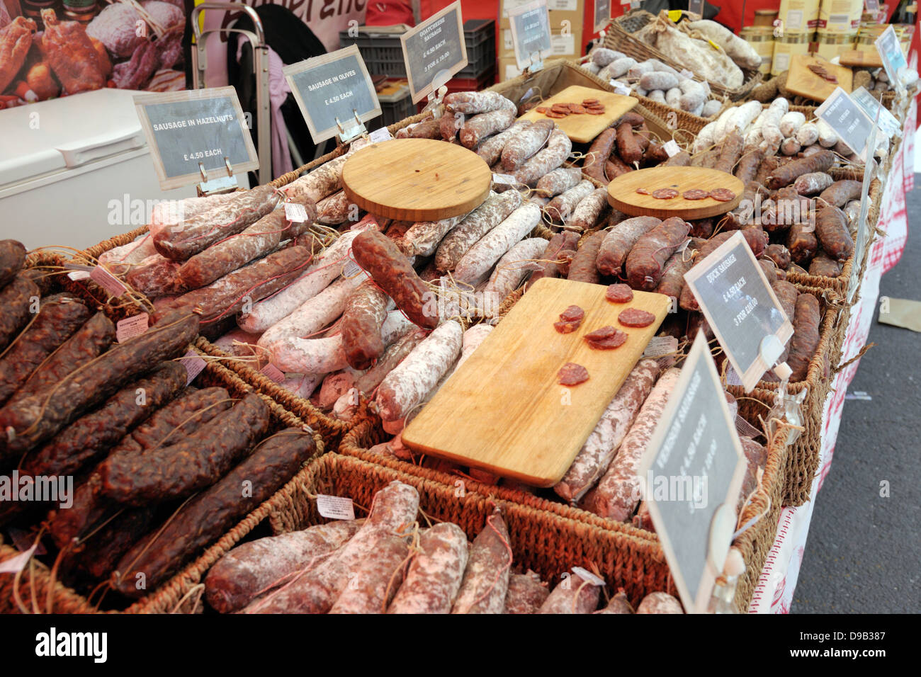 Dried speciality sausages on a market traders stall. Stock Photo