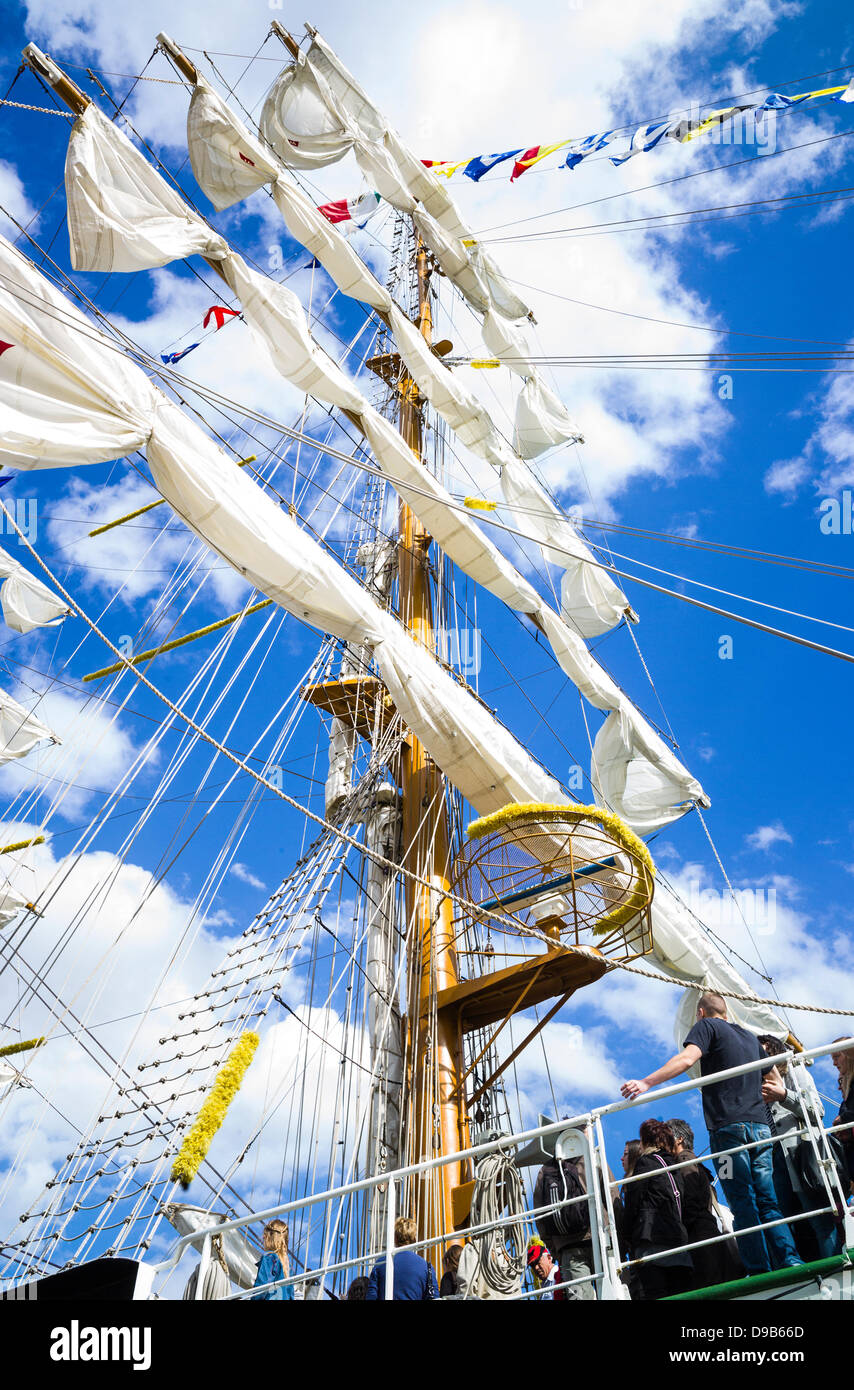 Rouen, France. 15th June 2013. Mexican Naval training ship, Cuauhtemoc at the Rouen Armada. Vivid blue sky with clouds. Vertical format. Dramatic view of mast and sails. Spectators are on deck. Stock Photo