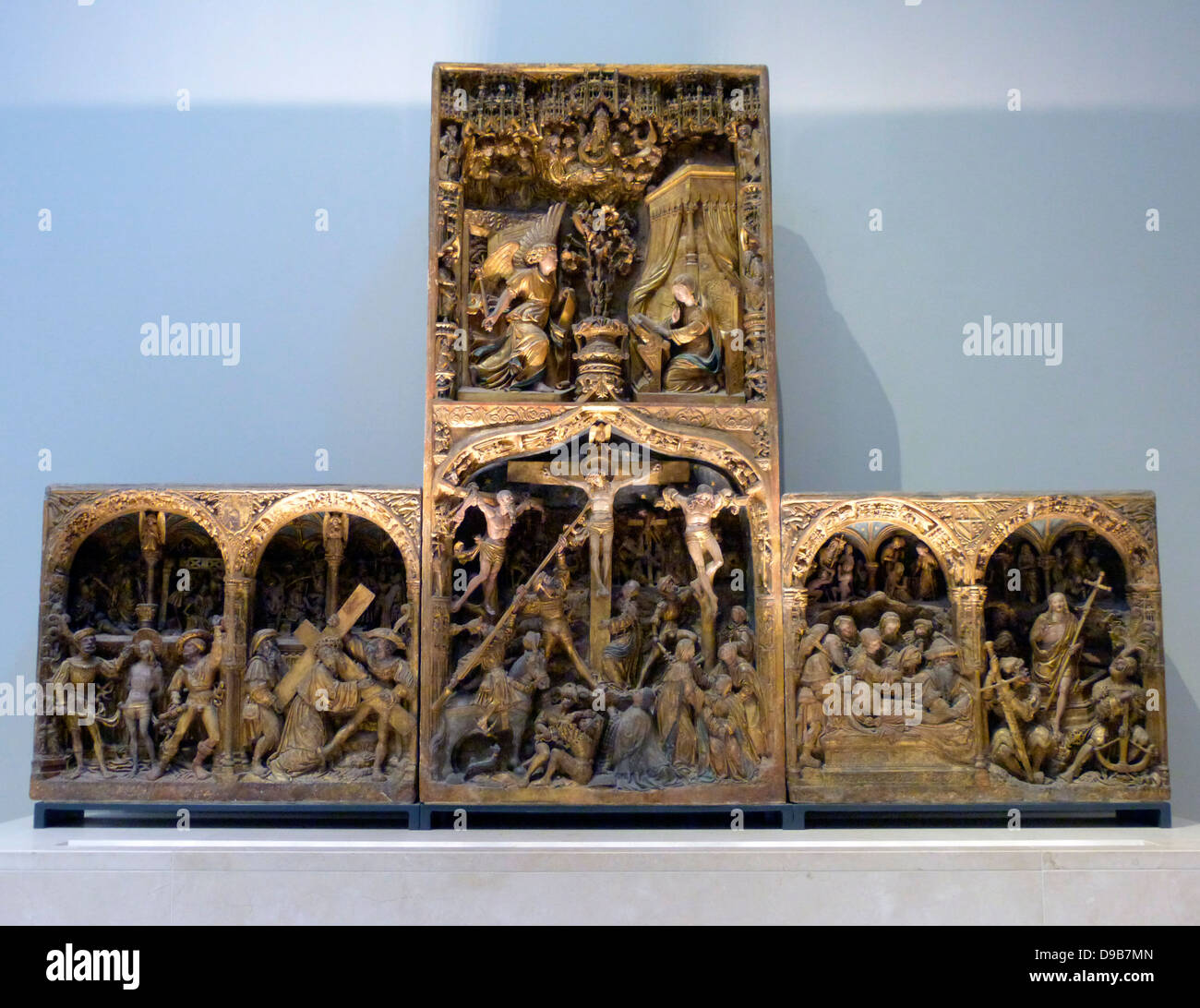 The Troyes Altarpiece circa 1525 (limestone, painted and gilded) was made for Jean Huynard the Elder, a lawyer who was elected dean of the chapter of Lirey in 1504.  Amid the scenes of Christ's arrest, death and resurrection, Jean can be found kneeling at the foot of the cross.  His family shields appear in the spandrels between the arches on the left and right sides. Stock Photo