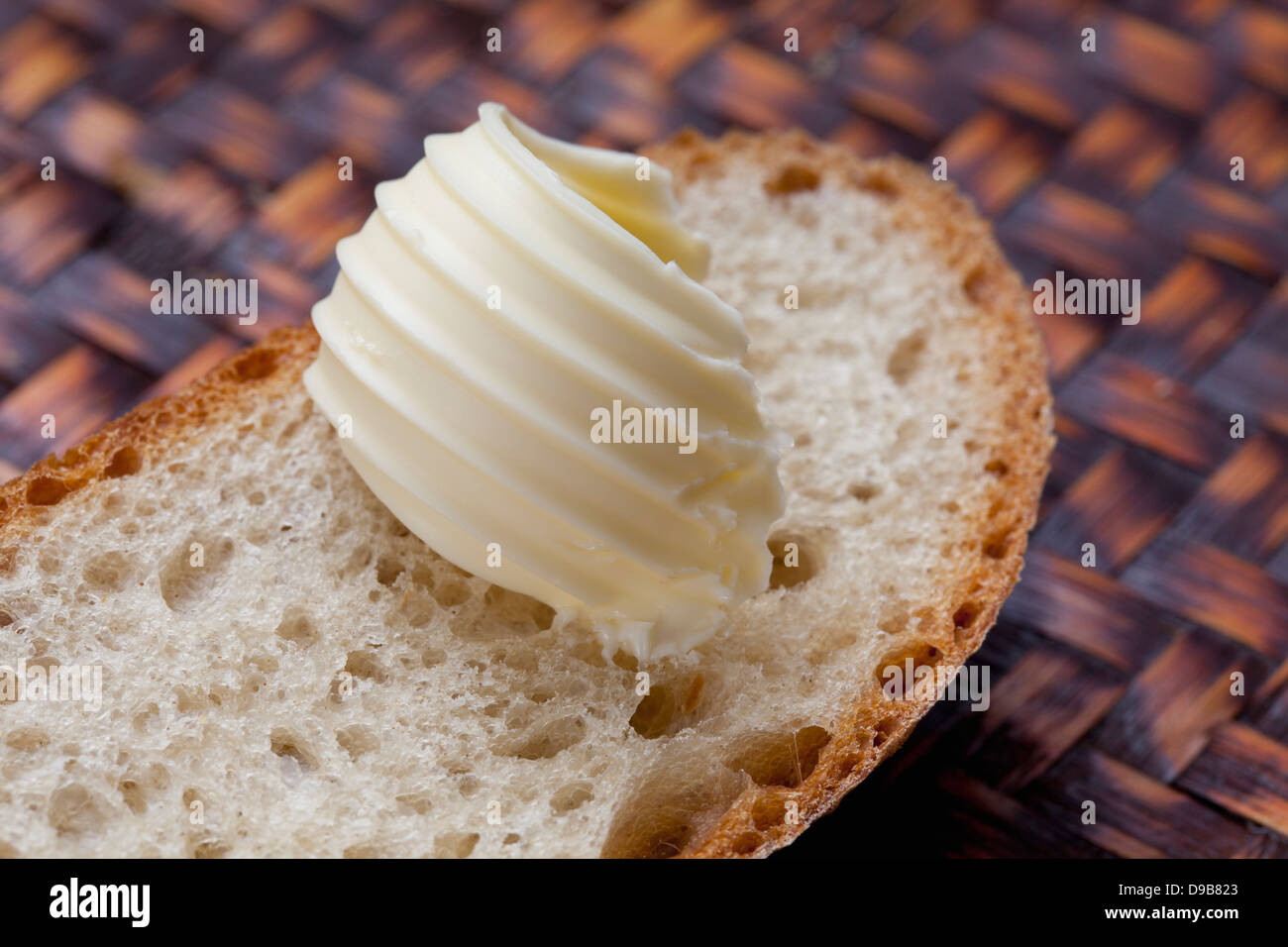 Slice of white bread with curl of butter, close up Stock Photo Alamy