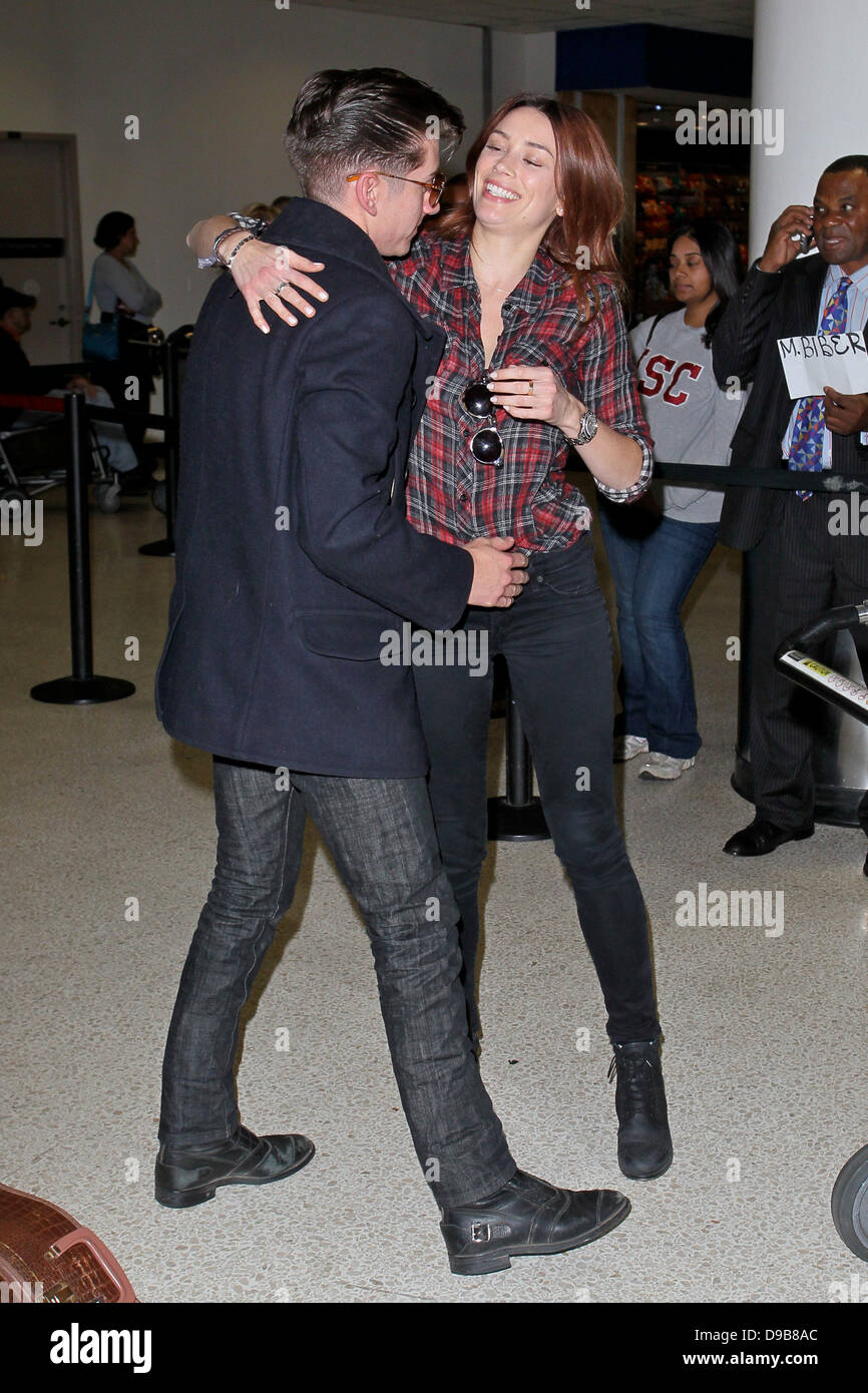 Arctic Monkeys star Alex Turner engages in a very public display of  affection with Arielle Vandenberg as he arrives at LAX Airport. Arielle  planted a big kiss on the rocker after jumping