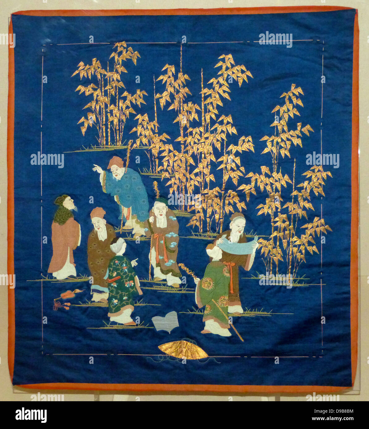 Gift cover.  Dark blue satin weave silk with embroidery.  The Seven Sages represent a group of third century Chinese scholars who met in a bamboo grove to relax, drink and discuss Taoist philosophy.  In Japan they are popularly equated with the Seven Gods. Stock Photo