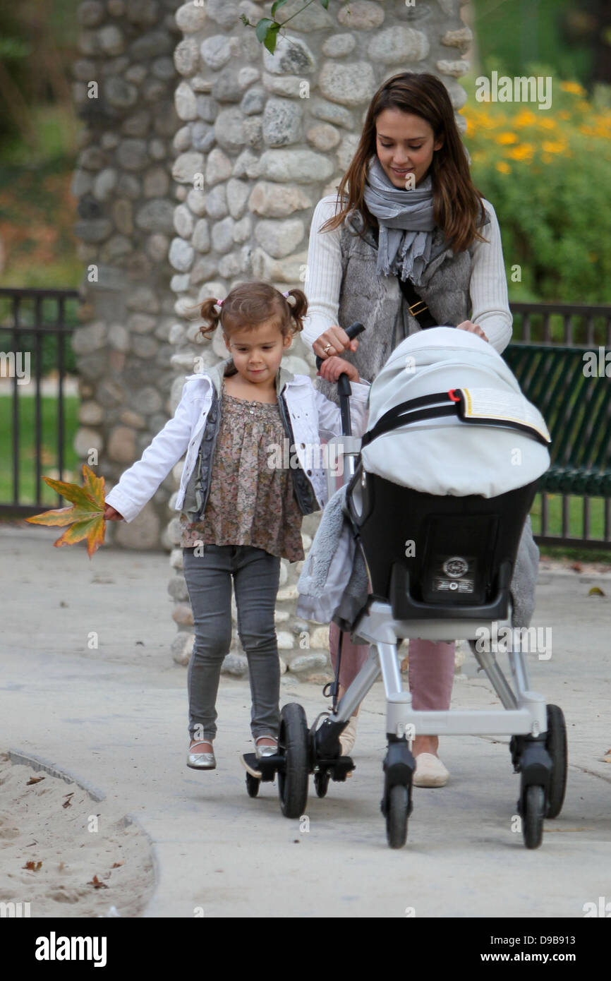 Honor Marie Warren hitches a ride on her sisters stroller as mom